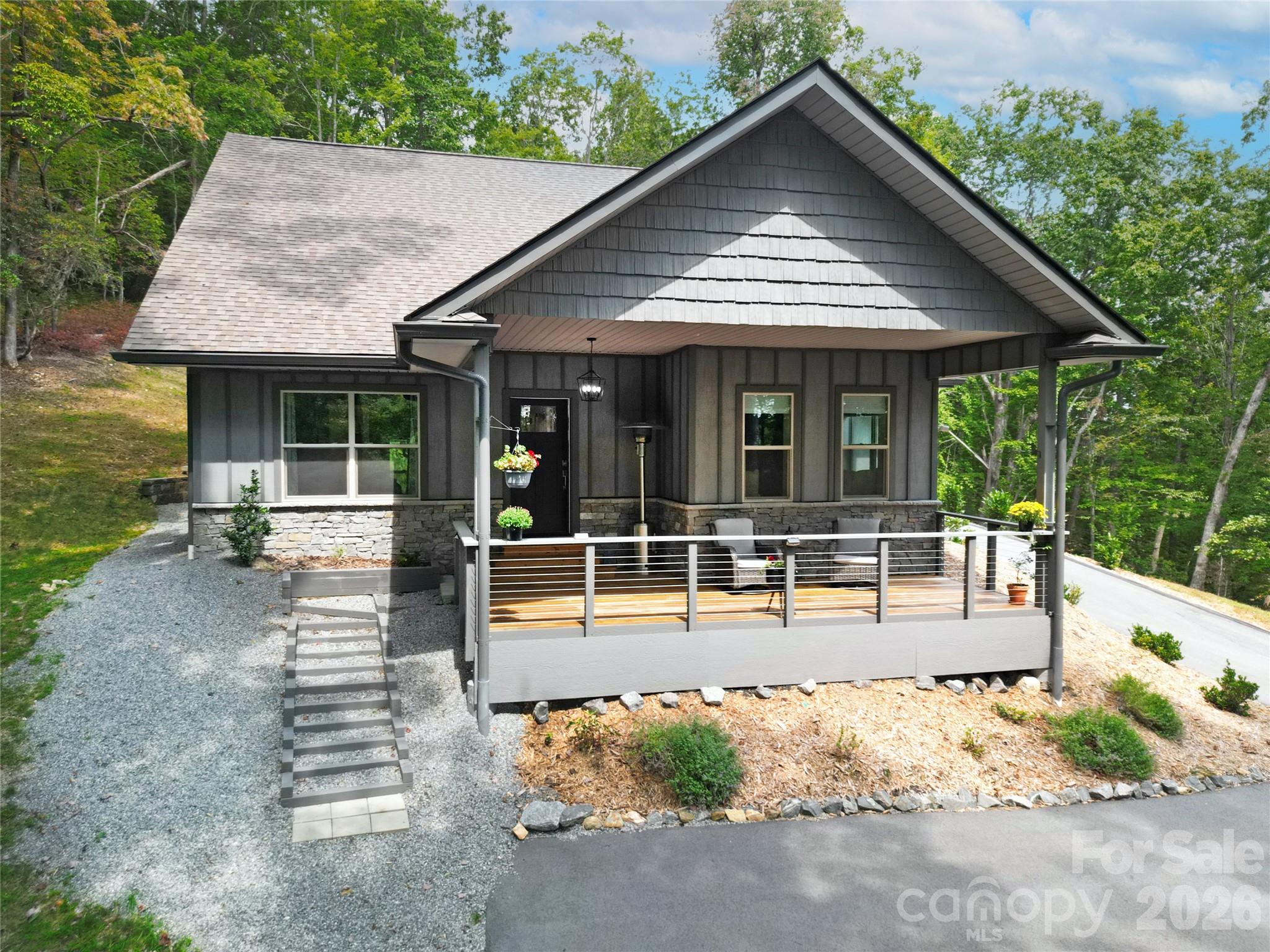 Mountain views 2 yr. New Modern Mountain Retreat Near Ticoa Lake.  Tucked away on a spacious and private lot, this beautiful 3-bed 2-bath home offers the perfect blend of peace, convenience, and quality construction. Located just minutes from the amenities you’ll enjoy the quiet serenity of nature with seasonal winter views & wooded surroundings. This modern home is energy-efficient, well-insulated, & designed for lasting quality. The open-concept living area is centered around a sleek gas-burning fireplace, perfect for cozy evenings at home. Neutral finishes, and natural light through out gives this home a fresh, move-in-ready feel a true clean slate for your personal style.The layout is functional and inviting, with all bedrooms on one level and thoughtful features like a two-car garage for convenience. Whether you’re looking for a full-time residence or a low-maintenance mountain getaway, this property offers the privacy and comfort you’ve been searching for.