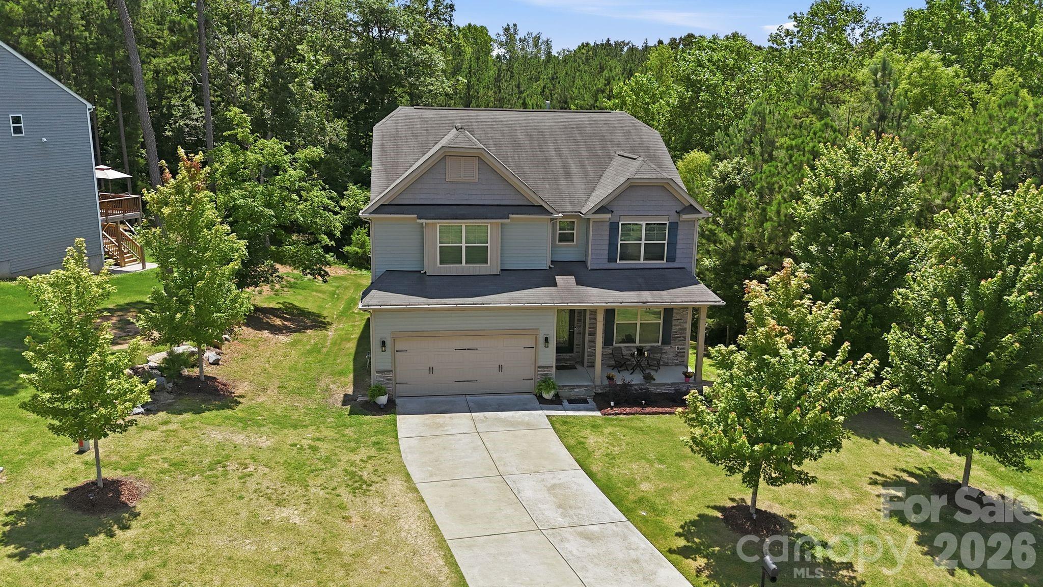 Experience a larger, more relaxed Lake Wylie lifestyle in this beautifully upgraded 6-bedroom, 4-bath modern farmhouse home offering 4,337 square feet of thoughtfully designed living space. Situated on a private 0.35-acre lot in Somerset Autumn Cove with only one neighboring home, this property provides the perfect blend of space, comfort, and convenience within the highly sought-after Clover School District.

The open-concept main level features luxury vinyl plank flooring, wood staircases, crown molding, custom wainscoting, designer lighting, and accent walls. The spacious kitchen is the heart of the home, showcasing granite countertops, a gas cooktop, abundant cabinetry, and a large center island with seating for four, all flowing seamlessly into the breakfast area, dining room, and family room.

The primary suite serves as a private retreat with a spa-inspired bath featuring a statement bubble chandelier, soaking tub, oversized walk-in shower, dual vanities, and a large walk-in closet. Upstairs, an open loft area offers flexible space for a playroom, office, or media room.

The fully finished walkout basement adds exceptional versatility with a bedroom, full bath, wine room, secondary living/media room, and additional flex space ideal for a gym, office, hobby room, or guest accommodations. Custom sliding farmhouse doors add character and style throughout.

Outdoor living shines with an elevated deck, covered patio, expansive backyard, and fire pit area—perfect for entertaining, relaxing, pets, play, and enjoying the outdoors. Just minutes from Lake Wylie’s boating, dining, parks, and recreation, this home offers the ideal combination of lake-area living and convenient access to Charlotte.