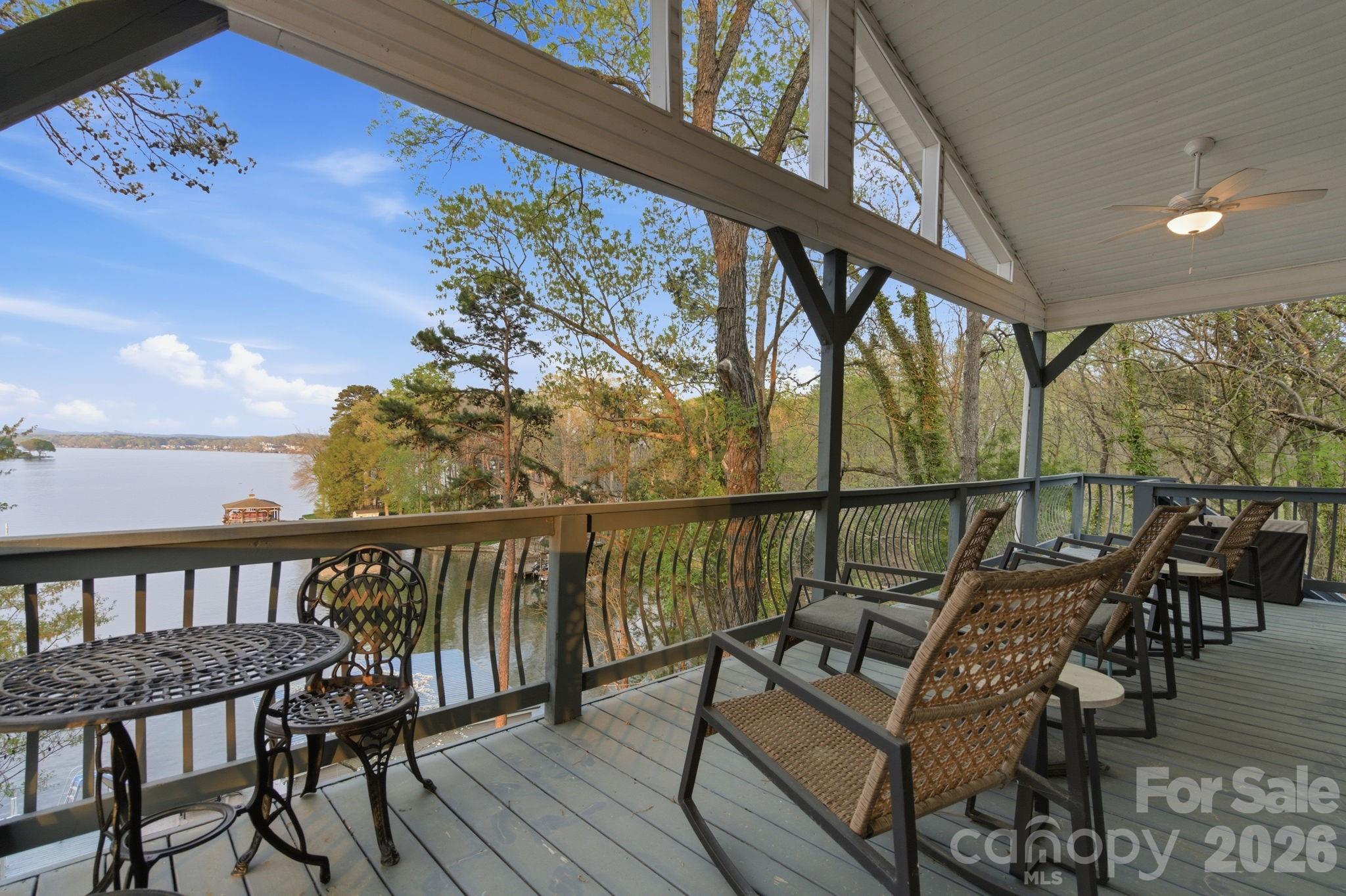 Discover an incredible Lake Tillery retreat with sweeping, long-range views of the Uwharrie Mountains visible from every level of the home. It’s not every day you find a property that offers both stunning lakefront scenery and mountain backdrops in one place. Inside, the main floor features a bright, open layout where the kitchen, dining, and living areas flow together, all framed by large windows showcasing the water. The home includes 3 bedrooms and 2.5 bathrooms, along with a sleeper sofa to accommodate extra guests. The primary suite is set apart on its own level, offering added privacy and a quiet escape. Each level of the home provides its own living space, including a fully finished basement with heating and cooling for year-round comfort. Outdoor living is just as impressive, with expansive decks and a patio designed to take full advantage of the views. Down by the water, you’ll find a large enclosed boathouse with two slips and lifts, plus an oversized dock complete with a built-in water slide for fun on the lake. There’s also a fire pit and a charming rocking chair spot perfect for relaxing evenings. With plenty of parking and being offered fully furnished, this property is move-in ready and set up for unforgettable lake days from the start.