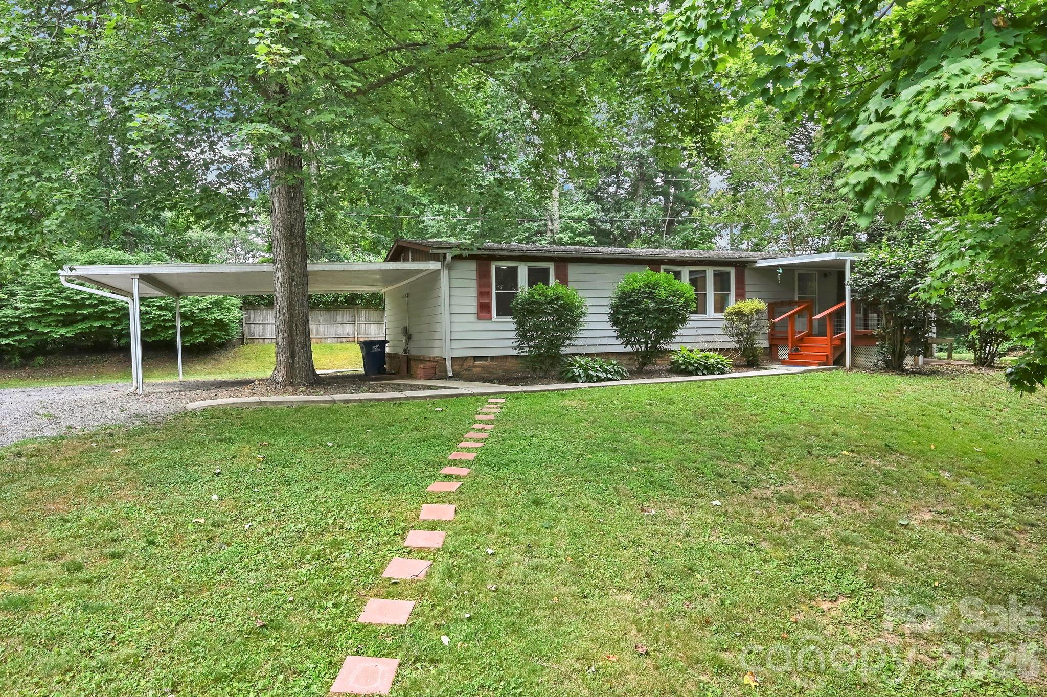 Location, Location, Location! Enjoy the perfect combination of convenience and peaceful living in this freshly painted 3-bedroom, 2-bath manufactured home in desirable Candler. Situated on a beautiful level lot, this move-in-ready home features a covered front porch, double attached carport, circle driveway, and concrete access to the backyard for added convenience. Spend evenings around the fire pit or take advantage of the spacious yard for gardening, entertaining, and outdoor fun.
Inside, the split-bedroom floor plan offers both privacy and functionality. The bright, open living area is enhanced by energy-efficient double-pane windows, while the kitchen features ample cabinetry, generous counter space, and a 2-year-old microwave, stove, and refrigerator. Every bedroom includes a walk-in closet, providing exceptional storage throughout the home.
A storage shed with a durable metal roof offers additional space for lawn equipment and tools. Central heat and air conditioning provide year-round comfort. 
Conveniently located just minutes from shopping, dining, schools, and I-40, you'll enjoy quick access to Asheville while appreciating the quiet charm of Candler. Whether you're a first-time buyer, downsizing, or looking for an investment opportunity, this home checks all the boxes!