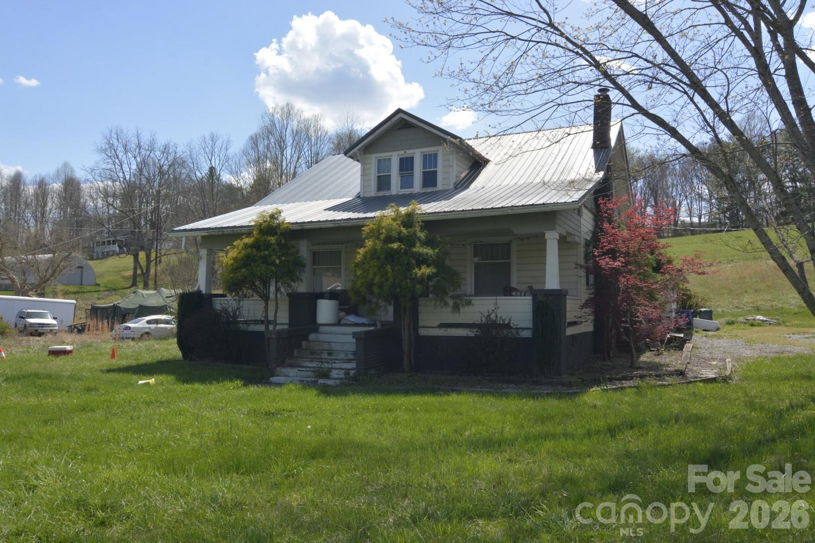 Property with many opportunities for commercial/office use or bring this home with its original hardwood floor and trim back to its grandeur.  Main level has a large living room and separate sitting room, dining room, kitchen, primary bedroom and bathroom.  Upstairs there are three bedroom and a bonus room that could make a nice office.  Home will need work but the bones are there and is being sold as-is.  Located 20 minutes to downtown Asheville come bring your vision.  Interior pictures will be upload soon.