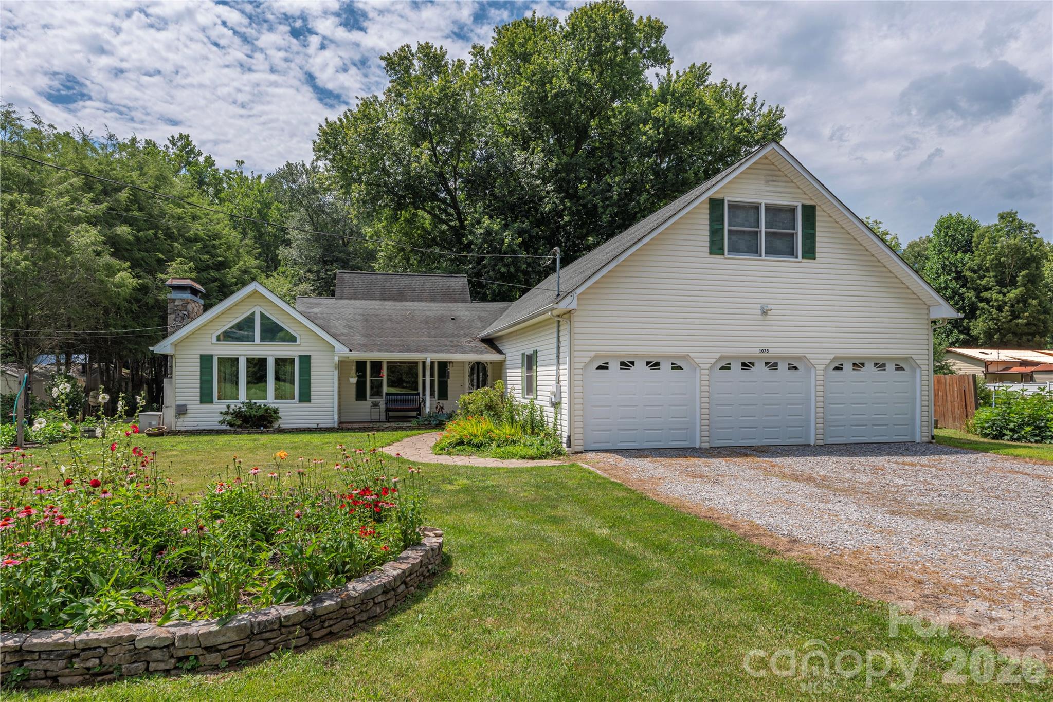 Discover the ultimate in mountain versatility and multi-generational living with this exceptionally well-maintained Maggie Valley home! Perfectly designed as two complete homes in one, this rare property features an interior-connected layout with separate entrances, making it ideal for extended families, a private guest retreat, or short-term rental opportunities. The sprawling 3,493-square-foot floor plan is thoughtfully divided to maximize privacy, boasting 2 fully equipped kitchens, 2 spacious living rooms, 4 generous bedrooms, and 3.5 bathrooms. Every detail of this contemporary site-built home has been carefully considered for comfort and convenience, from the spacious main-level living areas to the abundance of natural light. The outdoor features are just as impressive as the interior. Situated on a level 0.33-acre lot with beautiful Great Smoky Mountain views, the property offers expansive front-yard garden spaces perfect for cultivation, relaxation, or creating your own private mountain oasis. Location is everything—you are just a quick golf cart ride away from the prestigious Maggie Valley Club & Resort, and only minutes from downtown Maggie Valley’s vibrant restaurants, shops, festivals, hiking, skiing, and year-round outdoor recreation. With city water, city sewer, a 3-car attached garage, and no HOA fees, this Western North Carolina mountain home offers the perfect blend of space, charm, and exceptional lifestyle flexibility.