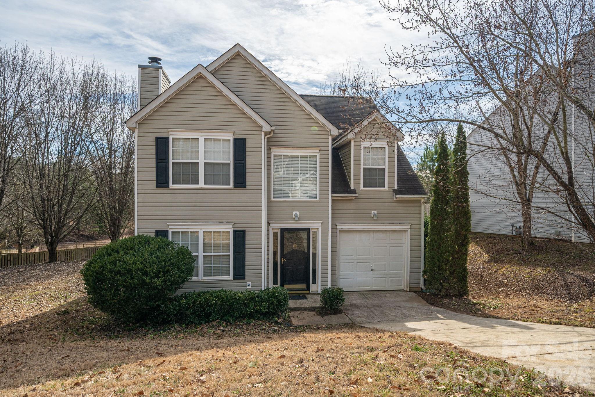 Located in the welcoming Forest Oaks neighborhood, this home tells a simple, honest story - the kind of place where everyday life just works. Step inside to a spacious living room that instantly feels like home, with durable vinyl plank flooring underfoot and a cozy fireplace ready for cool Carolina nights. The layout flows naturally into the kitchen, creating an easy rhythm for both daily living and hosting friends. The kitchen is built for real life, featuring a smooth-top range, built-in microwave, and a dedicated dining area where weeknight meals turn into unhurried conversations. Upstairs, the generously sized primary suite offers a quiet retreat with a ceiling fan and a private en suite bath complete with a separate shower and relaxing garden tub. The secondary bedrooms are roomy and versatile, perfect for family, guests, or a home office setup. Out back, a large deck overlooks the open backyard, offering the kind of outdoor space that invites cookouts, playtime, or peaceful mornings with coffee in hand. An attached garage adds everyday convenience, giving you space for parking, storage, or weekend projects. All of this sits within the sought-after Forest Oaks community, zoned for the award-winning Clover School District and benefiting from low South Carolina taxes. A comfortable, well-rounded home in a location that continues to make sense, both now and for the future.