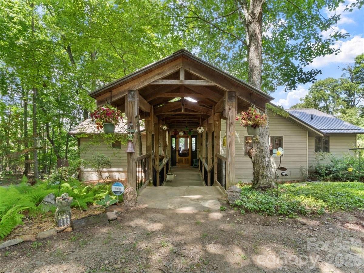 Welcome to Moonshine Mountain in beautiful Burnsville, where year-round, long-range views create a peaceful mountain retreat. This thoughtfully designed home features inviting living and dining spaces with heated ghost maple floors, Andersen windows, and a well-appointed chef’s kitchen with hickory cabinets, two full-size sinks, a pot filler, updated appliances, a microwave drawer, and a beverage refrigerator. Both main-level bedrooms offer walk-in closets and en suite baths finished with marble and stone tile and countertops. A spacious deck spans the back of the home, inviting you to relax, entertain, and take in sweeping mountain views that reach all the way to Tennessee. The finished basement is perfect for relaxing or entertaining, complete with a wood-burning fireplace, pool table, wet bar, wine storage, laundry area, kitchenette, slate and carpet flooring, heated garage, and a full bedroom suite with a Jacuzzi tub and walk-in shower. Enjoy added comfort with heated upstairs floors and generator wiring, plus beautifully maintained outdoor spaces featuring a rock patio firepit area and a manicured hillside.