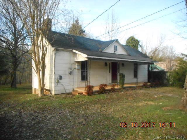 Most of the house has high ceilings except enclosed porch area, which is 217 HSF, includes bathroom and laundry, and is below 7 feet.  Great location, close to I-40, downtown, hospital, and restaurants. This 2 bedroom, 1 bath home on extra large lot has large rooms and each bedroom has 2 closets. Most windows have been replaced.  Sold AS-IS. Functionality of systems is unknown. Financing available through First National Bank of America.