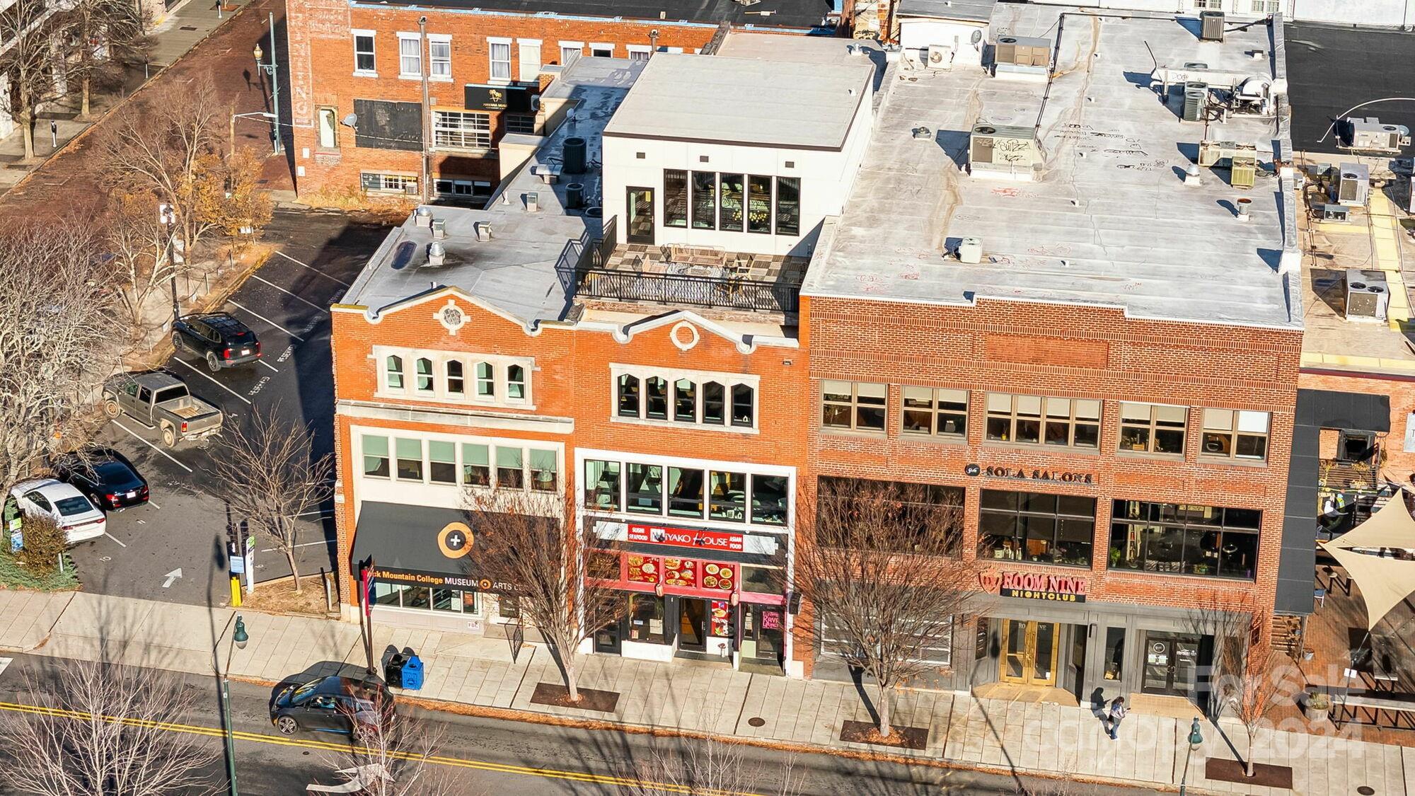 Welcome to 122 College Street—a rare opportunity to acquire a turnkey mixed-use asset directly on Pack Square with commercial income in place. No other properties can match the pairing of high-quality luxury residences with dependable commercial income—at a compelling basis of $387 per SF. 

All major capital improvements are complete. Offered fully furnished, the property is ready for immediate use or income generation. 

Upper floors feature two 2BR/2BA units and a 3BR/3.5BA luxury penthouse, all accessed via  private entrance. Highlights include exposed brick, high ceilings, large windows with city and mountain views. The penthouse has 25’ ceilings, a 380 SF loft, and the only private rooftop terrace overlooking Pack Square Park, a truly spectacular amenity.

Below the residences are two fully leased commercial spaces: a 3,000 SF street-level restaurant with a full commercial kitchen and a 3,000 SF lower-level bar, providing dependable income in one of Downtown Asheville’s most visible and active locations.

Ownership options include holding as a turnkey mixed-use investment, occupying or leasing the residences, or pursuing a condominium conversion strategy with potential to resell individual units at pricing more consistent with Downtown Asheville’s luxury residential market.

Currently offered at $4,600,000 | $387 per square foot.