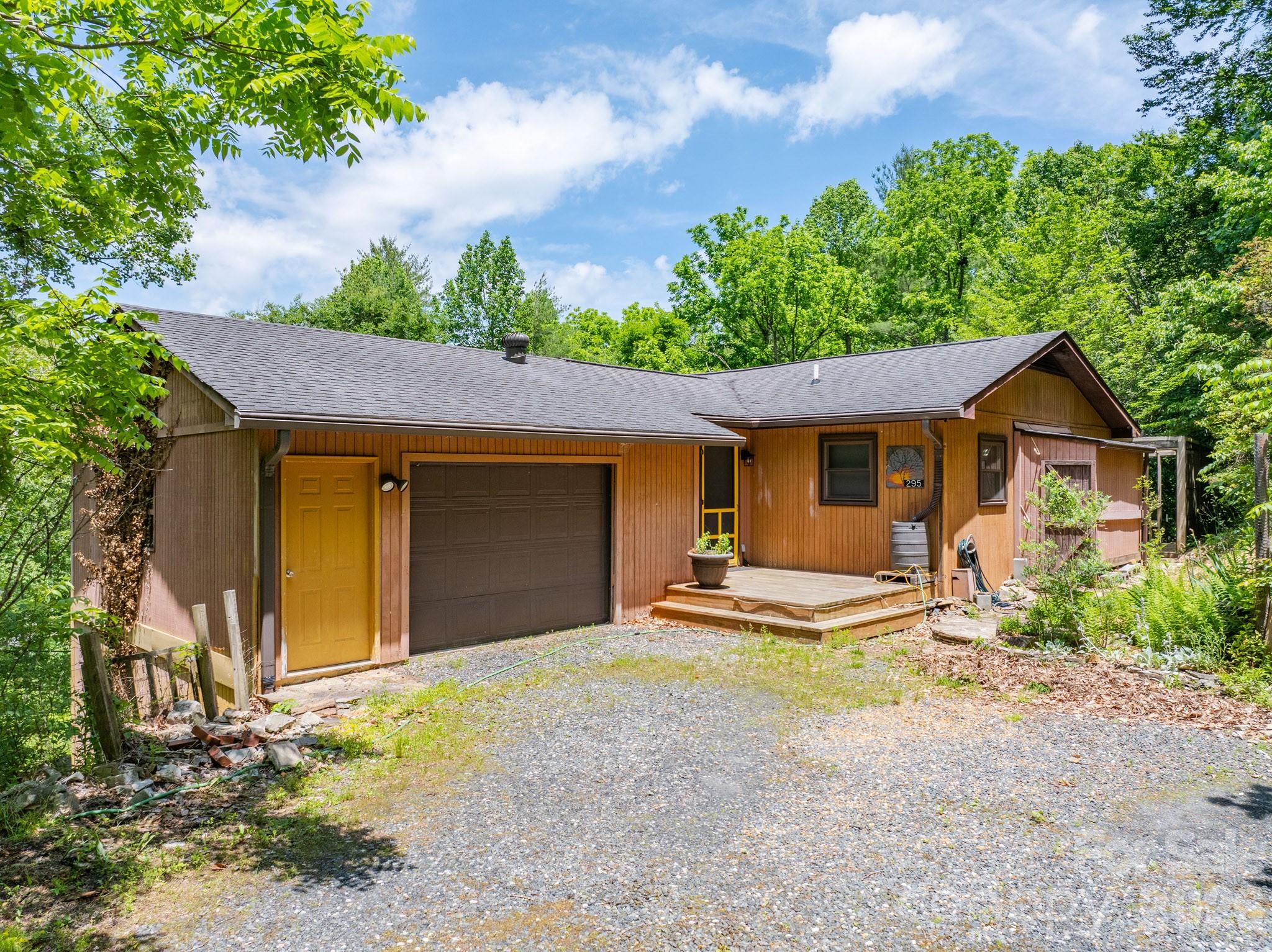 Rustic cottage located just minutes from the charming town of Bakersville, offering the perfect blend of character and convenience. Inside, the living room showcases unique multi-wood flooring and a striking stone hearth that once housed a woodstove, creating a warm mountain-cabin feel. The home's cozy atmosphere and rustic details make it an inviting retreat for full-time living or a weekend getaway.

Outside, the property offers mini-farm potential with some areas already fenced, providing opportunities for gardening, hobby farming, or a few livestock. The shed/barn has not been used in several years. Whether you're searching for an affordable starter home, investment rental, or mountain escape, this property offers plenty of potential.

Conveniently located within an hour of Johnson City, Asheville, and Boone. Outdoor enthusiasts will appreciate the area's abundance of hiking opportunities, scenic mountain beauty, and proximity to the renowned Bare Dark Sky Observatory. The region is also known for its thriving arts community, including nearby Penland School of Craft, and a rich tradition of local artisans and makers that have long made this mountain area a destination for creativity and craftsmanship. Come explore this peaceful setting filled with the timeless charm of the North Carolina mountains.