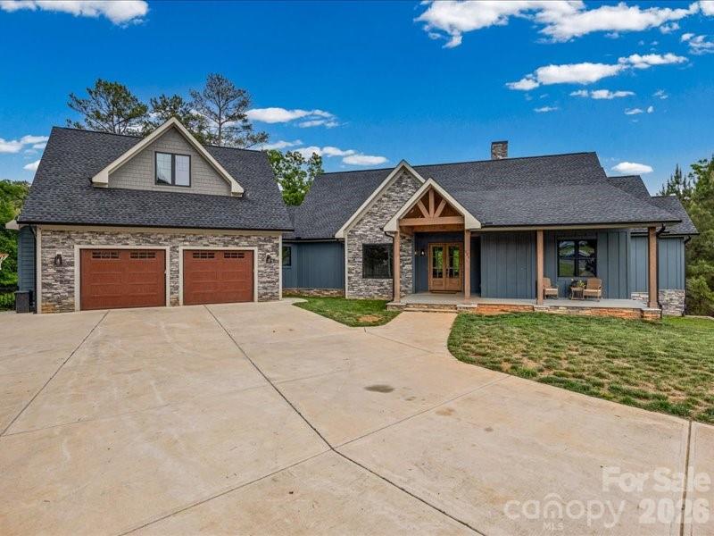 For People Who Don't Like Just Plain Living! Located on a large cul-de-sac lot with a deep water cove! Per the seller, even during drought times there is still plenty of water to get your boat in & out. No boat rocking like on the main channel. This house includes a chef's kitchen with a subzero refrigerator, Wolf commercial style stove and 2 beverage refrigerators. Five bedrooms ( 2 up and 3 down). Downstairs there is a family/rec room, exercise room & a large laundry room with lots of storage. There are 2 garages, one on the main level and one on the bottom level. No carpet!
Relax on the abundance of porches and decking. Close to highly rated schools & easy commute to Charlotte.
The neighborhood has boat storage, playground & pool
