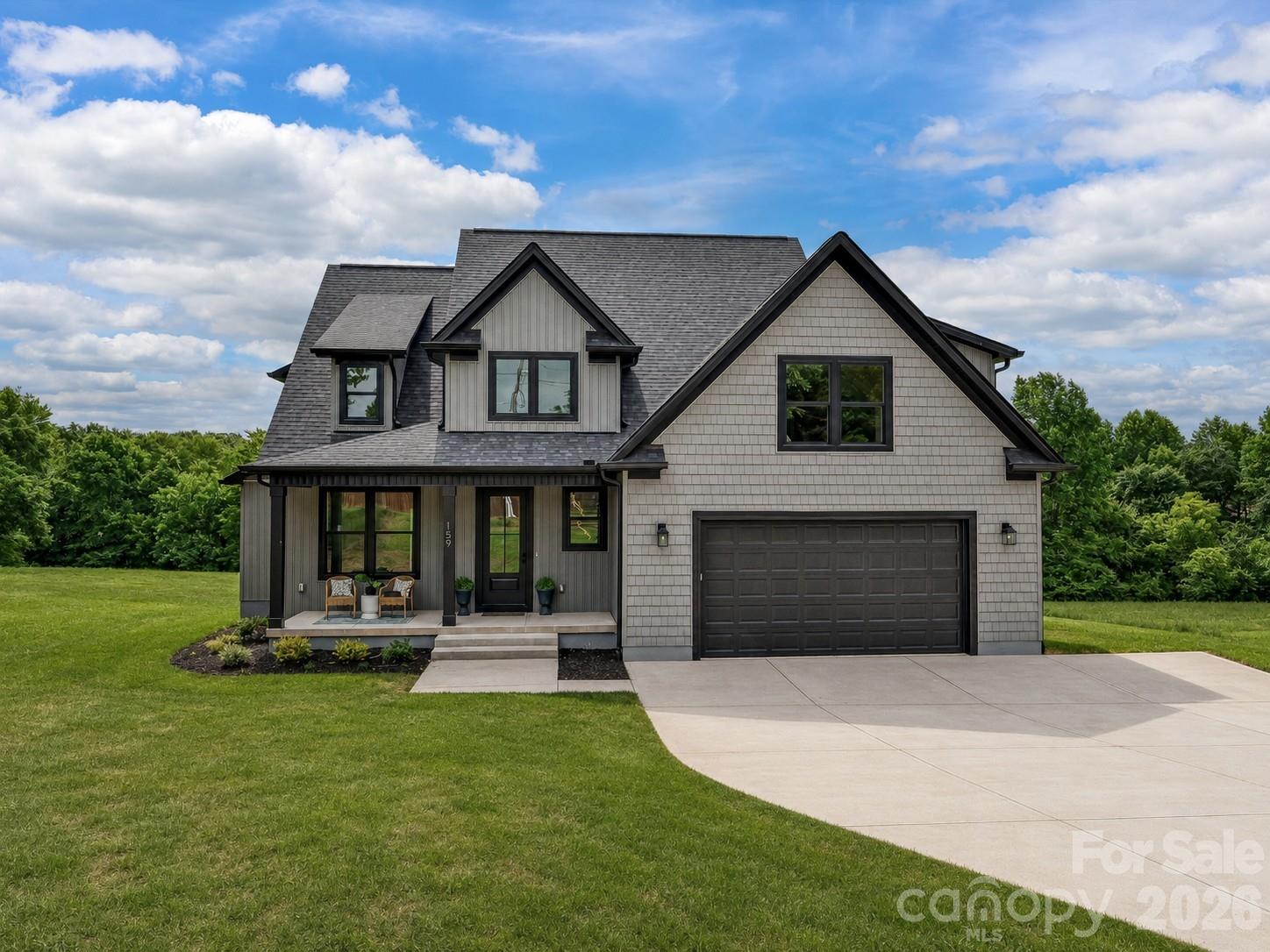 Experience luxury living in this beautifully designed, newly built home situated on a private and expansive 2-acre homesite surrounded by peaceful tree-lined views. The open-concept layout showcases a stunning great room with soaring ceilings, abundant natural light, and seamless flow into the gourmet kitchen featuring quartz countertops, stainless steel appliances, custom cabinetry, a large center island with seating, walk-in pantry, and spacious dining area perfect for entertaining. The main-level primary suite offers vaulted ceilings, scenic backyard views, a spa-inspired ensuite bath with dual vanities, soaking tub, oversized tiled walk-in shower, and a generous walk-in closet. Additional flexible living spaces include a secondary bedroom or home office, spacious upstairs bedrooms, a large bonus room ideal for a media room or playroom, and three beautifully appointed full baths. Enjoy outdoor living year-round on the covered back porch overlooking the expansive backyard and serene natural surroundings. Additional highlights include a dedicated laundry room, designer finishes throughout, and exceptional indoor-outdoor living space perfect for relaxing or entertaining.