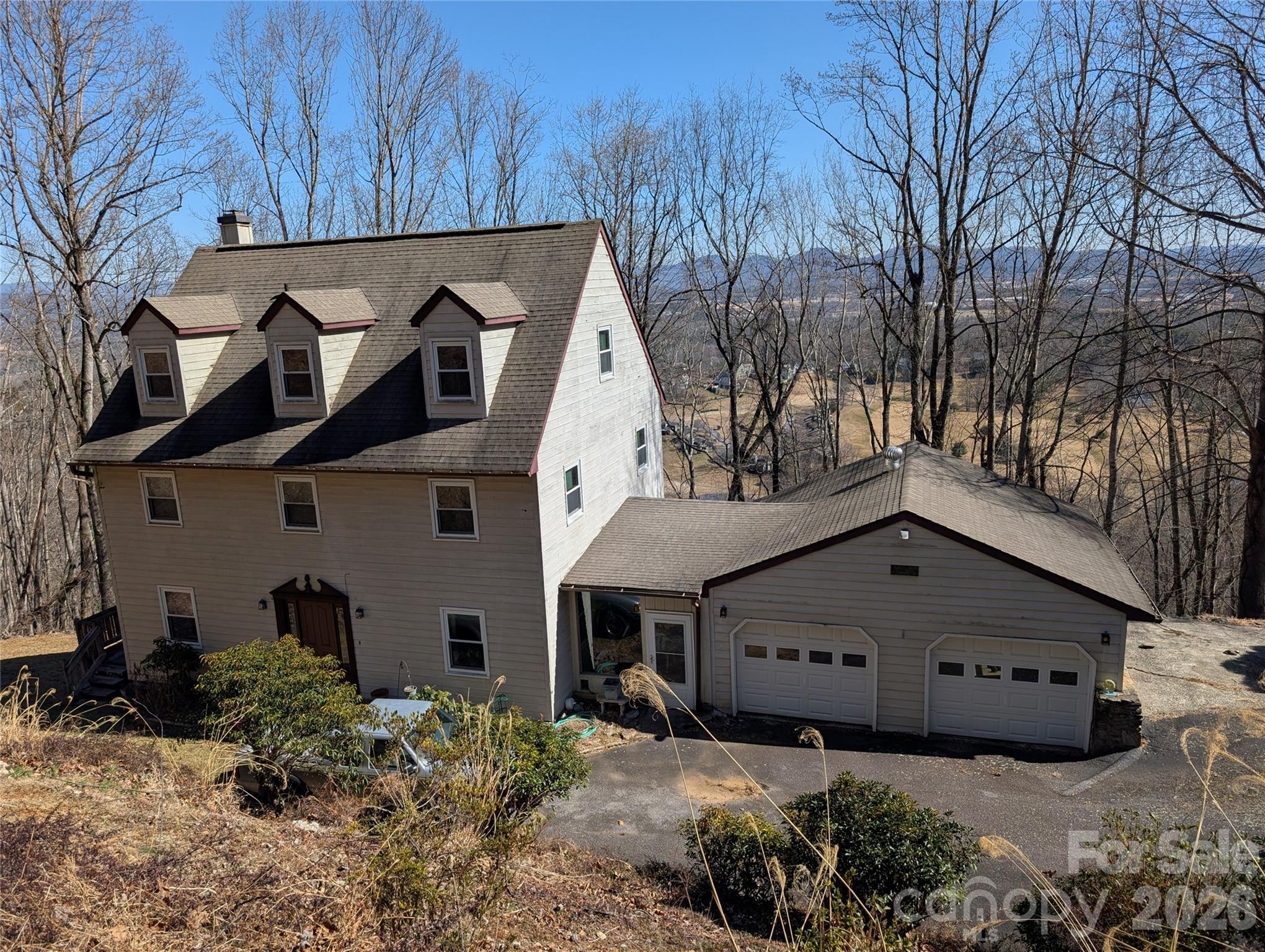Nestled within the prestigious gated community of High Vista in Mills River, this residence offers a serene mountain lifestyle on a generous 1.19-acre lot. The home features just over 2,000 square feet of living space, highlighted by an expansive large deck designed specifically to showcase breathtaking, long-range mountain views that change with the seasons. There is plenty of room to expand in the unfinished basement with rough plumbing already installed for a bathroom option. Residents of this sought-after neighborhood enjoy access to a wealth of community amenities, including a clubhouse, outdoor pool, tennis courts, and a premier semi private golf course(not included in the dues). With its classic wood siding and dated interior, this property serves as the perfect canvas for those looking to create their ideal mountain retreat in a location that feels worlds away yet remains conveniently close to the essentials of Mills River and Asheville. This property has major structural damage along the back side of the garage and breezeway. There are signs of water damage around the entry door.  The home is priced with these repairs in mind.