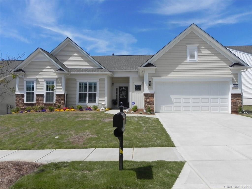 Almost new!  Crestwood Meadow 3BR/2.5BA home w/sunroom, screen porch & paver patio overlooking a large greenspace.  It features stacked stone elevation, gourmet kitchen, granite and new dark stainless 4-door counter depth  refrigerator, electric cooktop, wall oven, tile backsplash, pull-out shelves & under-cabinet lighting. Hardwoods thru out, carpet in BRs and tile in baths. Extended garage w/permanent steps to attic storage. Come check out the active adult lifestyle of Sun City Carolina Lakes.