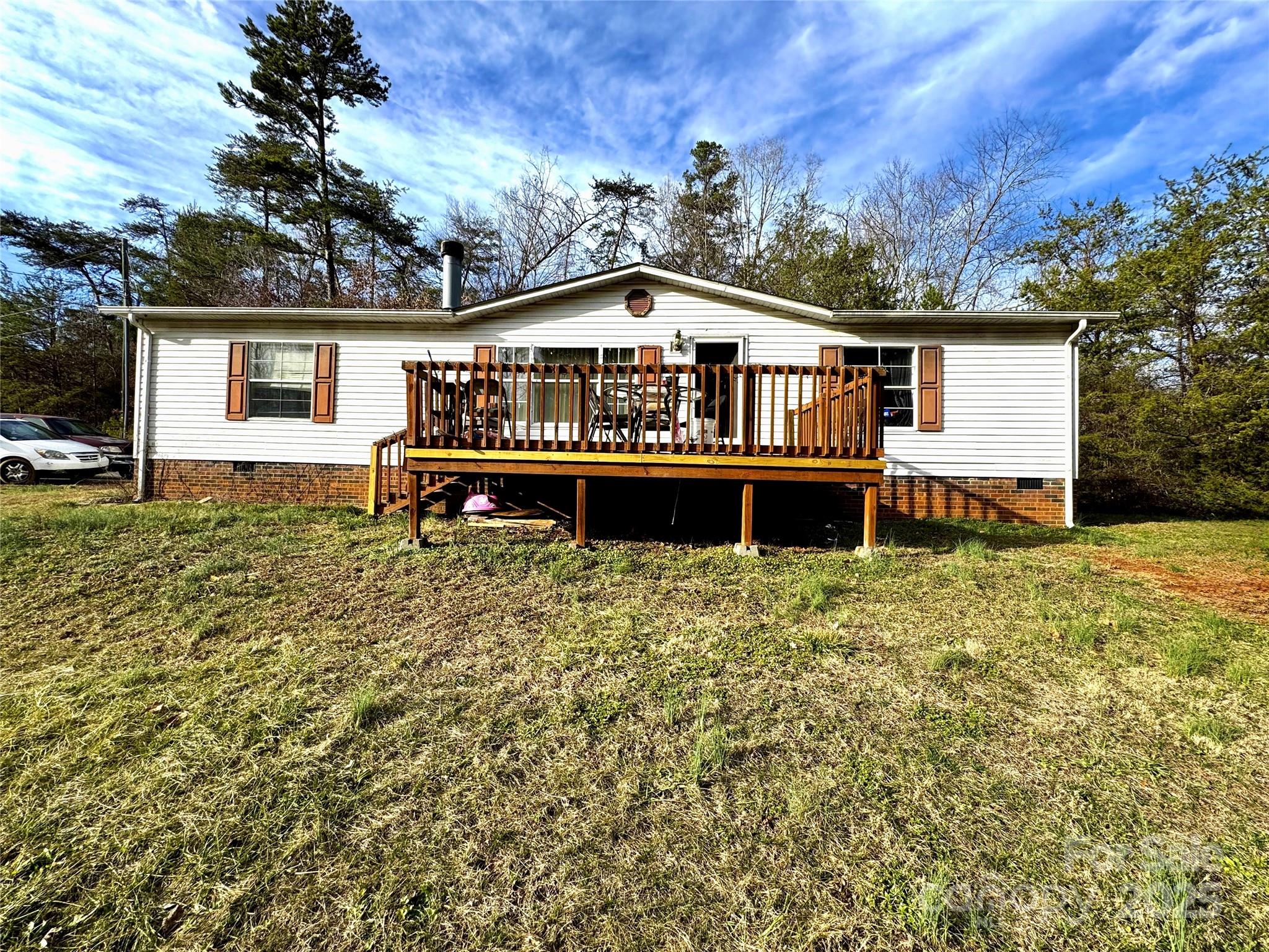 Discover this double-wide home on a permanent foundation that offers comfortable living with newer HVAC components (new motor installed last year) and multiple heating options, including a central system and a wood-burning furnace. The home features hardwood flooring in the dining and living areas, carpeted bedrooms, and easy-to-maintain linoleum in the kitchen and baths.

Outside, enjoy driveway parking for up to 4 vehicles. The home is set on a cinder block foundation with a vinyl exterior and an asphalt shingle roof for durability. Laundry is conveniently located at the back of the house.

Showings by appointment only—please note that a dog is on the property and will be secured prior to any visits. Don’t miss this great opportunity in Morganton!