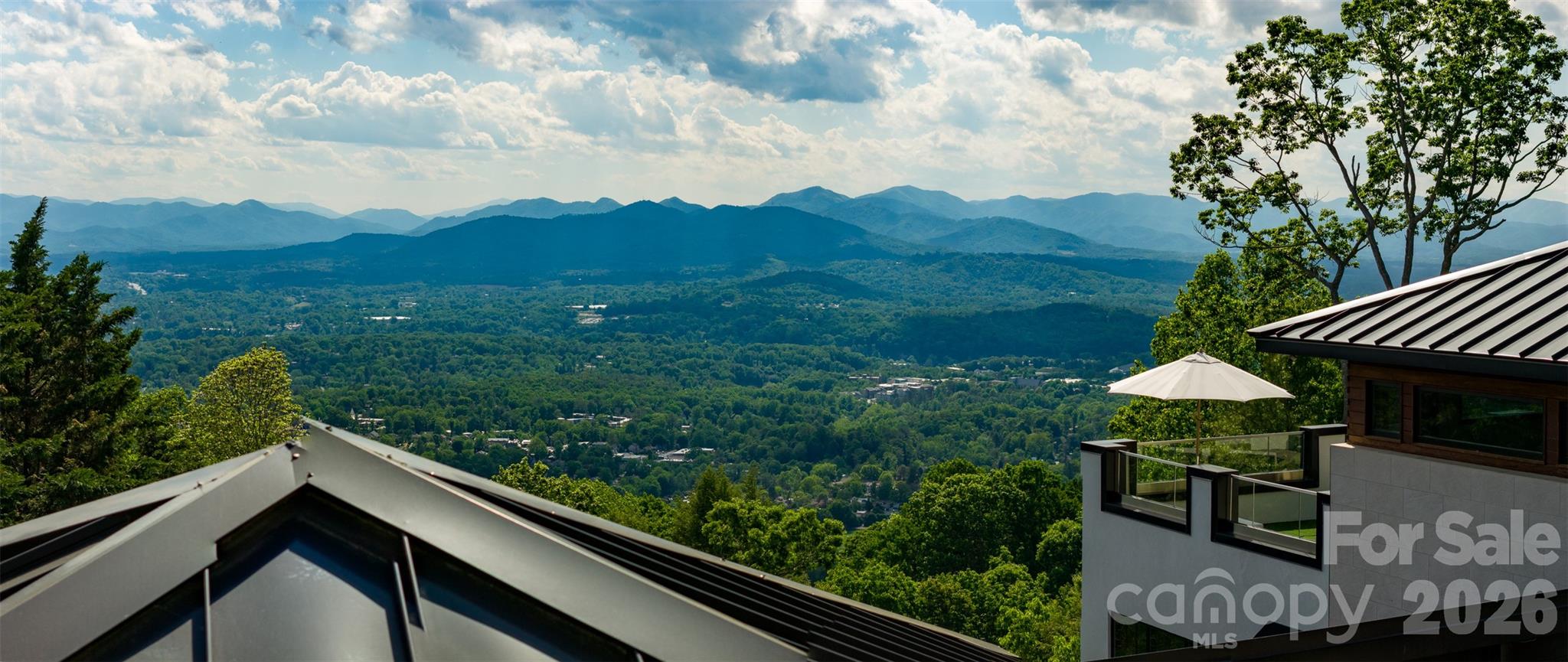 A superior home. A superior location. And on permanent display — one of the absolute best vantage points this entire city has to offer.
Perched atop Sunset Mountain, 12 Sunset Summit delivers a commanding year-round panorama of the Blue Ridge Mountains that few properties in Asheville can rival. And the sunsets here are in a category entirely their own. Night after night, the western sky ignites in gold, amber, and deep violet directly from your home— the kind of view people drive to the mountains hoping to find, and never quite do.
All of this, just minutes from downtown Asheville.
Rebuilt in 2021 to a standard worthy of its setting, this contemporary residence spans nearly 5,000 square feet across two fully finished levels. Walls of glass, soaring sightlines, and a design centered entirely on the landscape make the mountains feel like a living part of every room.
The main level flows effortlessly from a chef's kitchen — with an island and walk-in pantry — through dining and living spaces anchored by a gas fireplace, all opening to that extraordinary backdrop. The primary suite is a private sanctuary with those same mountain views. A home office, walk-in pantry, and mudroom keep daily life organized and elegant in equal measure. Even the powder room makes a statement — a switchable privacy windows that frames the view until the moment you want it not to, a small but telling detail about how thoughtfully this home was designed throughout.
Then there is the rooftop terrace. Sunsets unfold in full panoramic color. As evening deepens, the mountain sky above reveals a canopy of stars that is genuinely rare this close to an urban center — elevated enough to escape the light, private enough to make it yours alone. This is where mornings begin with coffee and mist drifting through the valleys, and where evenings end under a sky that reminds you exactly why you chose this place.
The lower level adds over 2,200 square feet of beautifully finished living space: a covered outdoor living room for year-round entertaining, a family room, a rec room, a wet bar, and two guest suites with walk-in closets and private deck access. Curated gardens, stone terracing, specimen plantings, and dramatic evening lighting complete an estate that is as striking after dark as it is at dawn.
There are homes with views. And then there is this one.

Make sure you watch the Video/Virtual tour to see the best views and home details. VIEWS, VIEWS, VIEWS.
LOCATION, LOCATION, LOCATION.