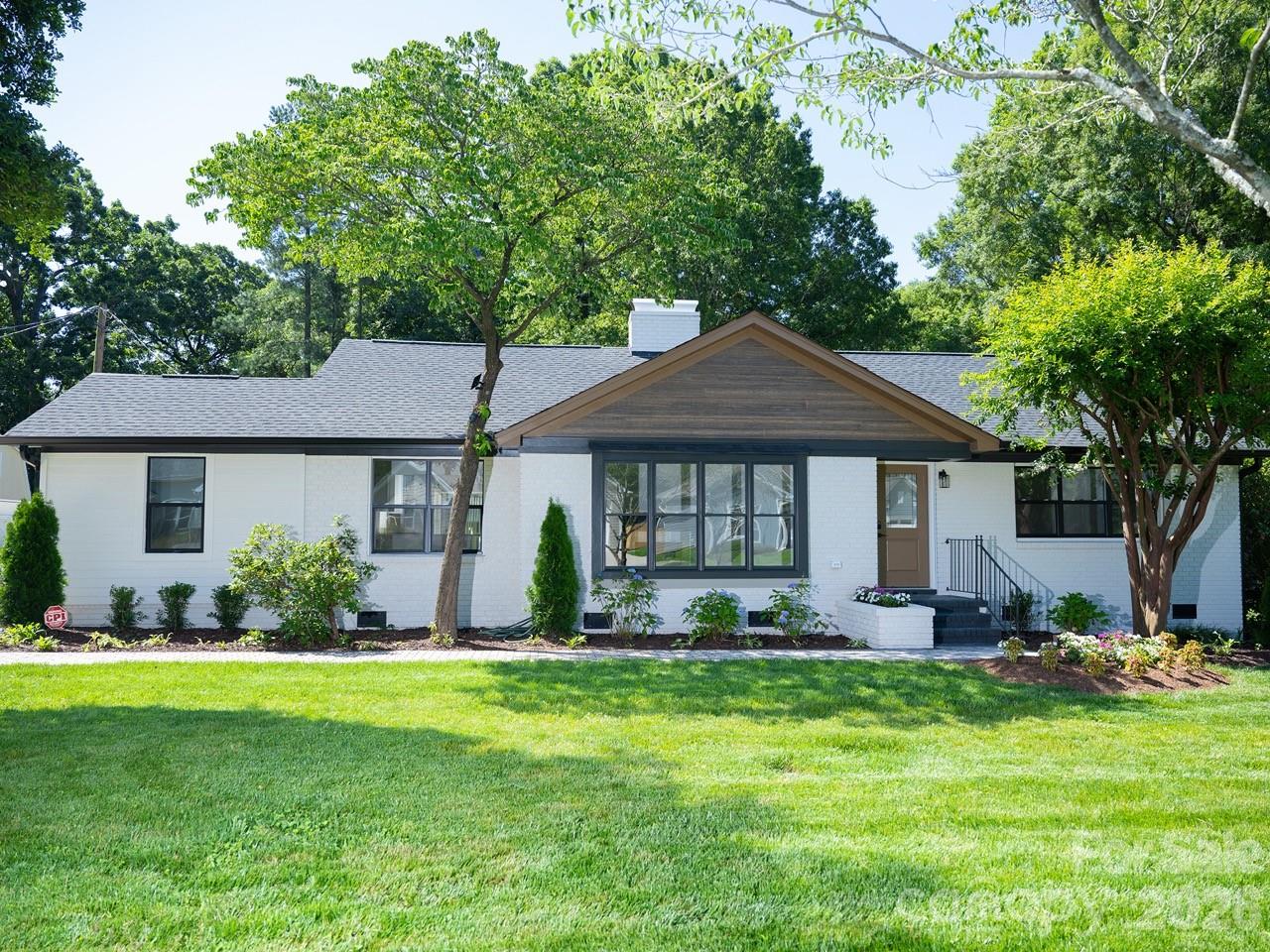 This fully renovated, brick ranch-style home features 4 bedrooms and 2 bathrooms. It offers two living areas—including a bright sunroom—and a layout that provides spaciousness and flexibility for modern living. Situated on a generously sized lot, the property includes a detached one-car garage with storage space, as well as a fully renovated attached studio apartment; this space is ideal for hosting guests and everything an independent studio has to offer. It boasts a fantastic location just 3 minutes from Interstate 85 and 10 minutes from downtown Charlotte, placing it close to shops, restaurants, and everything the city has to offer. The living room features a gas fireplace and large windows, while the sunroom offers a serene space bathed in natural light. The exterior is equally impressive; the 0.37-acre lot provides ample space for outdoor activities and relaxation, complemented by beautiful landscaping. The property is connected to municipal water and sewer services. Notably, there is no Homeowners Association (HOA), allowing for greater freedom and flexibility. This extraordinary home is a unique gem in a prime location, promising a perfect blend of comfort and convenience.