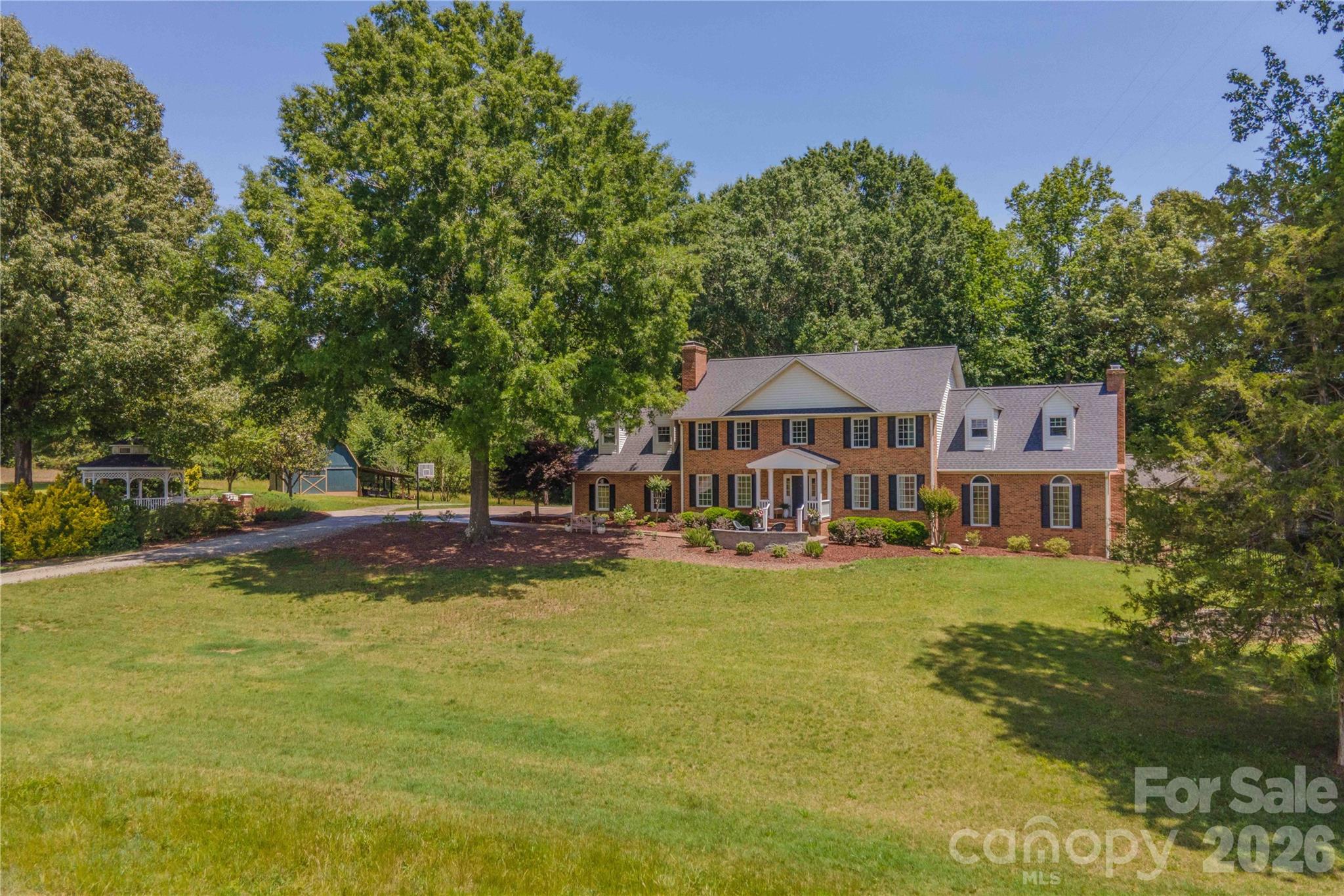 First time on the market for this stunning North Davidson estate! This extraordinary rural retreat beautifully blends modern luxury with timeless tradition. Situated on 20.02 acres, this one of a kind property offers the privacy & serenity of country living while still delivering luxury & sophistication. Nearly 3,900 sq ft, this beautifully updated home features, grand living spaces, exceptional natural light & quality craftsmanship. The custom renovated kitchen is a true showpiece with quartzite countertops, professional-grade appliances, custom cabinetry, designer finishes, and heated floors in bathrooms adding an extra touch of luxury. The property continues to impress outdoors with an expansive entertaining deck, gazebo, barn, rolling acreage, and a beautifully updated 900+ sq ft cottage ideal for guests, a private office or studio. Enjoy peaceful rural living with convenient access to Winston-Salem & Charlotte. Properties of this caliber rarely become available in North Davidson.