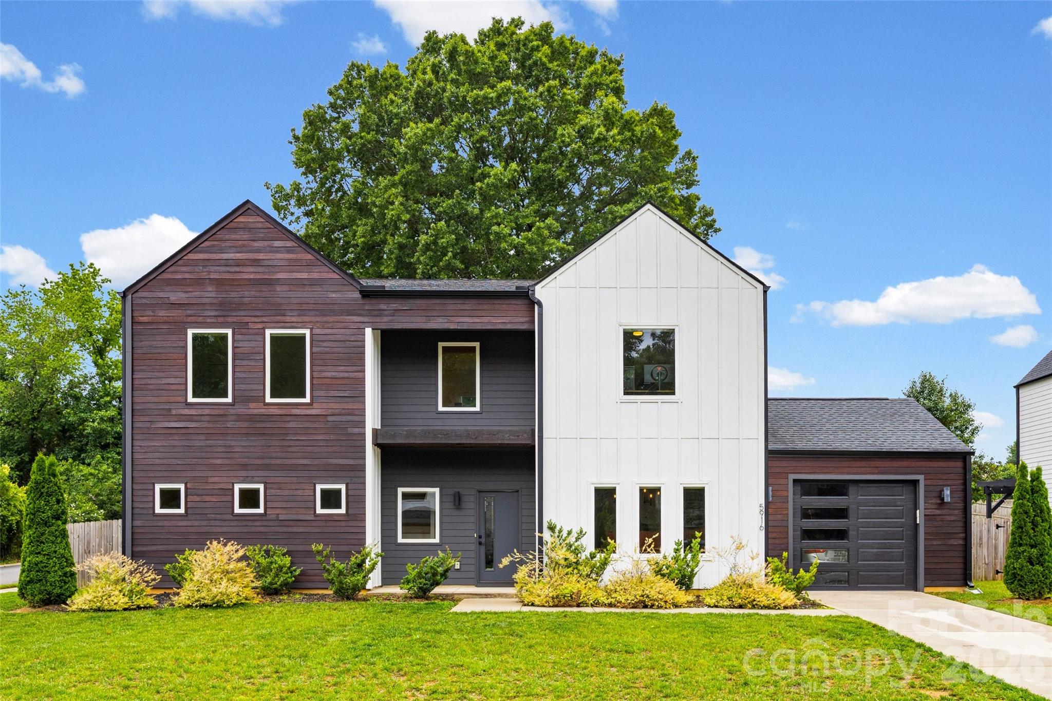 Architecturally distinctive modern home in Lake Mist featuring over 2,600 square feet of light-filled living space. Open floor plan with an oversized island, hardwood floors, designer finishes, fireplace, luxurious primary suite, upstairs reading nook. The spacious primary suite serves as a private retreat with dual walk-in closets and a spa-inspired bath complete with a freestanding soaking tub, oversized tiled shower, and dual vanities. Step outside to a wood-fenced corner lot with room to run, play, and make it your own. Ideally located minutes from Plaza Midwood, NoDa, and Uptown Charlotte. A rare opportunity to own one of Charlotte’s most unique contemporary homes with no HOA!