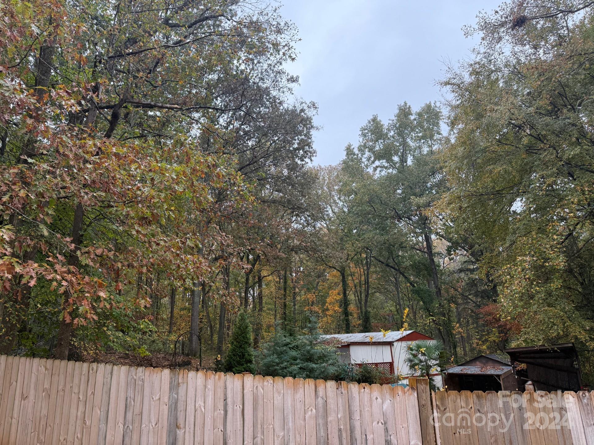 INCREDIBLE LOCATION!!! 1 1/2 acres of land in 29708 ready for a buyer to build their dream home or property have a 2 Bed 1 Bath singlewide manufaactored.  This lot has lots privacy and mature trees. The location can't be beat minutes away from Carowinds Blvd, I-77, and Rivergate shopping center. Award winning Fort Mill Schools and no HOA.  Sold As is  Buyer to verfy all information