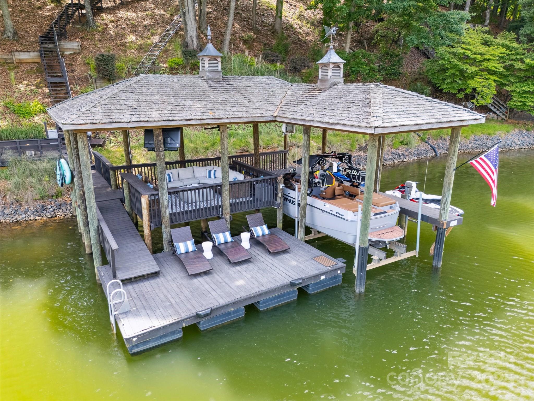Waterfront on Lake Wylie in Tega Cay, SC. Great Dock Design! Covered Boat Lift, 2 Wave Runner Lifts, Covered Dock for seating, Built in Counter Seating, & Floating Dock. Beautiful Lake House in Tega Cay, SC.  NO HOA, Fort Mill Schools. Open Floor plan. 4 bedrooms, Office, Great Room plus cozy Living Room with fireplace.  Gourmet white kitchen with 5 burner Gas Range, 9.5 ft Island, plenty of counter space, Stainless Appliances, Quartz countertops & coffee bar.  Natural wood floors, Plantation Shutters, designer lighting. Decks off the great room, living room, kitchen & primary bedroom. Large heated & cooled unfinished storage area approx 480 sq ft. Walk down to the lake or take the Tram!  Easy access to the dock. Just over the border from Charlotte, NC. Close to I-77, 30 min to Charlotte & CLT.  Enjoy the recreational lake city of Tega Cay.  Waterfront parks, boat ramps, beaches, sport courts, pickleball, tennis, Tega Cay Golf Club, Tega Cay Beach & Swim Club, walking trails, & more.