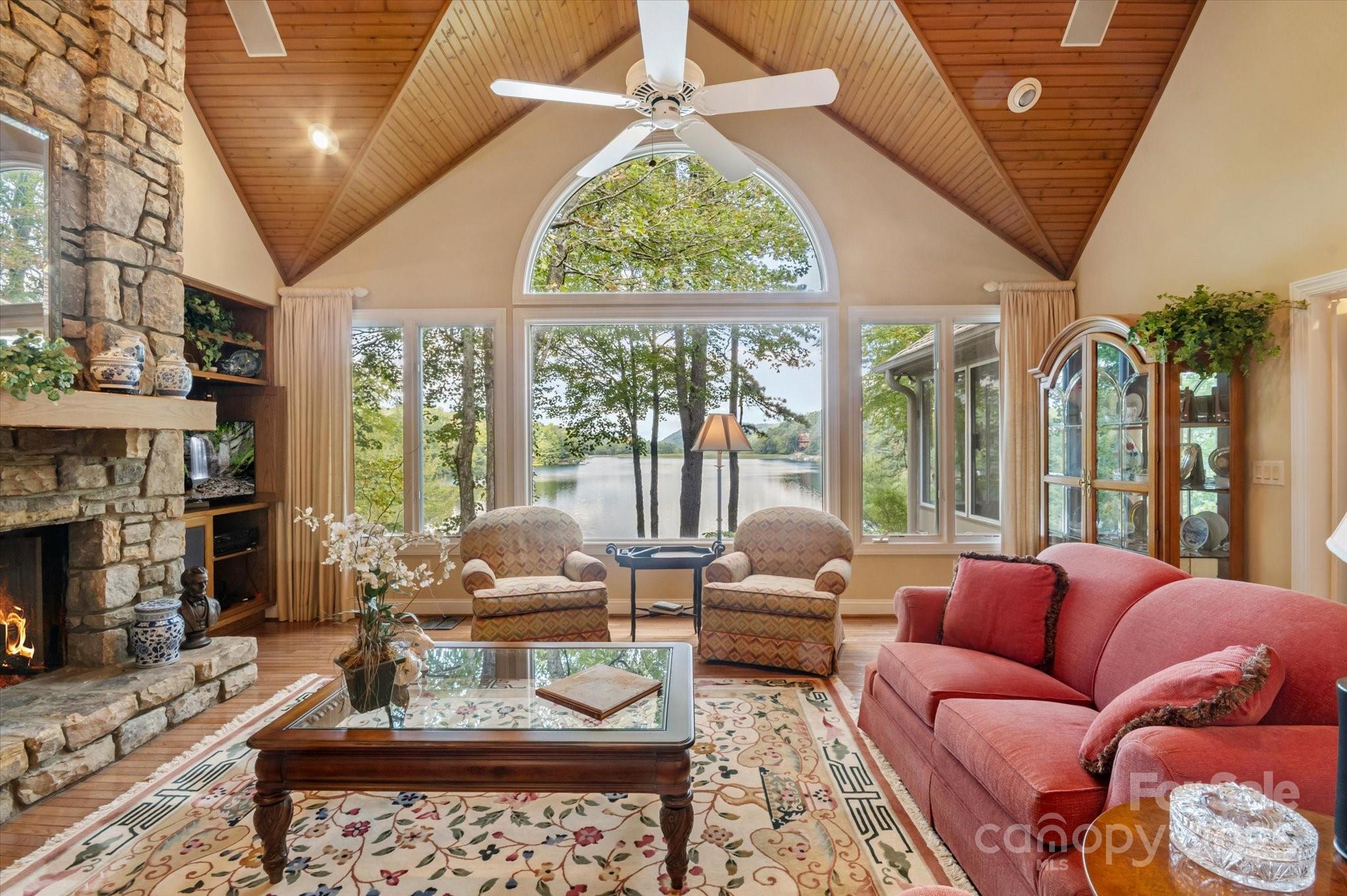 Situated on beautiful Lake Ticoa in the gated community of Connestee Falls, this furnished 5 bedroom, 5 bath home is truly a special place.  With plenty of room to entertain and a gorgeous year-round view overlooking the lake and mountains, this custom home boasts main level living, a stacked stone fireplace with vaulted ceilings, a beautiful sun room,  views from nearly every room and an oversized garage with workshop space. With a lower floor to very comfortably accommodate guests and common areas large enough for everyone to comfortably gather, this home will be the place your loved ones want to be. Connestee amenites include club house, swimming pool, 4 lakes, fitness center, golf course, tennis & pickleball courts, walking trails, and dog park.