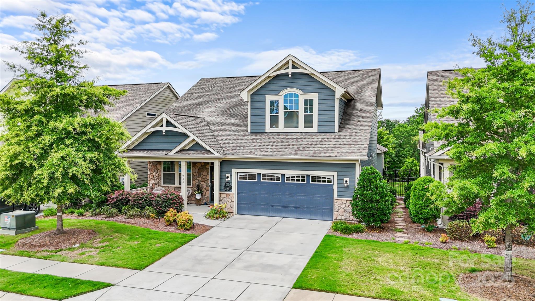 This charming Cottage Style Home in the popular Cadence Community features a primary BR on the main with a sitting room or flex room, a 2nd BR on the main, a spa like primary bath with a walk in shower, dual vanities and amazing customized closet that pass through to the laundry, mud room and drop zone. The open plan boast a large kitchen island, wall oven, gas cooktop, designer subway tile, a custom hood vent, elegant granite counters, a gas fireplace, a relaxing side porch with a remote controlled pergola, and a huge private, fenced backyard. Upstairs features a 3rd BR, a walk in closet, full bath, a spacious bonus room with a built in media console, a dry bar w/ a beverage refrig and surround sound. This home also features a walk in attic, a storage closet under the stairs and additional storage in the garage. Enjoy maintenance free living with lawn care included, plus a community pool, sidewalks, walking trails, and easy access to parks, Lake Wylie, shopping, restaurants and more!
