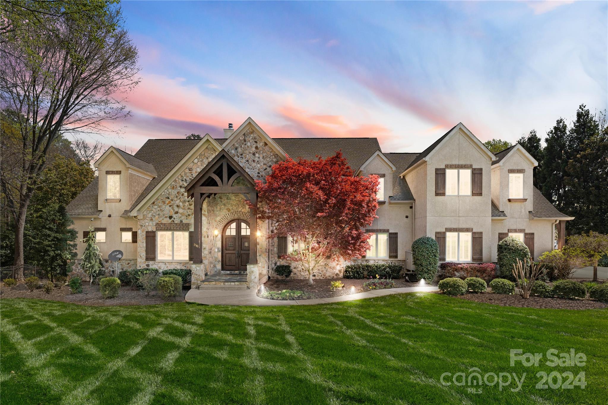 PRICE IMPROVEMENT!!  Welcome to this luxurious LKN residence. Boasting an impressive array of amenities and architectural marvels, this home promises an unrivaled living experience. As you approach the estate, you are greeted by a stunning façade combining stately stucco and striking stone accents that blend with the mature, manicured landscape. The grand entrance welcomes you into a foyer adorned with slate tiles and a sweeping staircase, setting the stage for the opulence within. The heart of the home is the spacious living room, where exposed beams and an imposing stone fireplace create an inviting atmosphere. Wide-plank hardwood floors lead you to a gourmet kitchen, featuring top-of-the-line appliances, custom cabinetry, and a large island. Outdoor living is redefined with a stunning stone patio overlooking the sparkling pool and LKN. The home also features a personal gym and a recreation room with a billiards table and a second kitchen, perfect for hosting guests.