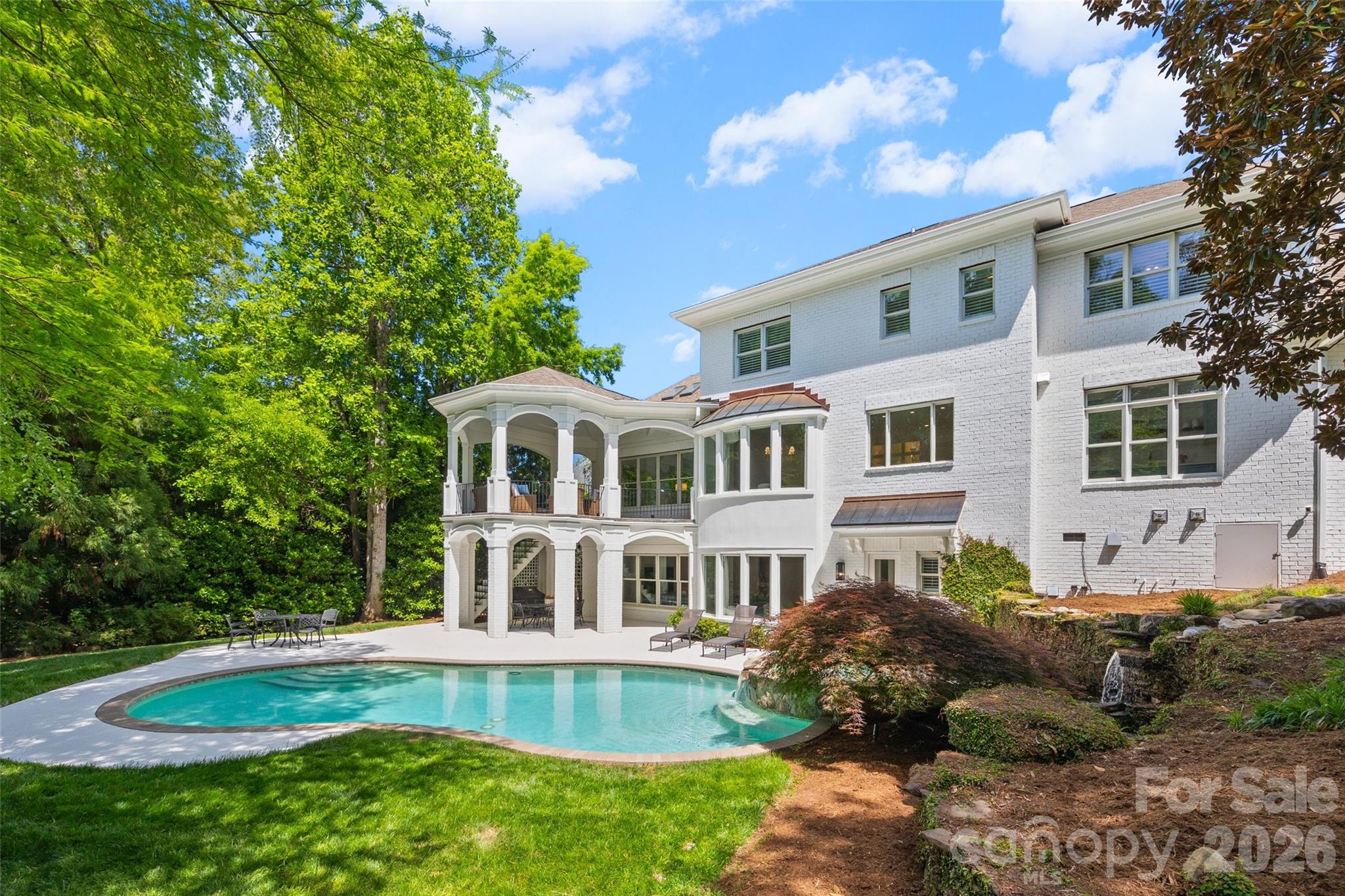 Rare opportunity to own a completely renovated home situated on a quiet 0.48 acre cul-de-sac lot in the beautifully established Ballantyne Country Club community. The work has been done so you can simply move in and enjoy this stunning updated home with resort style outdoor living space.  An 11 month “to the studs” renovation and addition completed in 2024 included new electrical wiring, plumbing pipes, and interior insulation, as well as new high end appliances, plumbing fixtures, cabinetry, countertops, tile, stairs, lighting, solid core interior doors, door hardware, interior trim, frameless shower enclosures, mirrors, and new 5" white oak site finished floors throughout the entire main and second levels.  The homeowner who is an interior designer reworked the layout of the home to create a large kitchen with a beautiful scullery, a luxurious primary suite with two large custom closets and spa like bath, three bedrooms with large en suite baths, and an office.  The huge laundry and mudroom area can accommodate the busiest of families.  The fully redesigned and renovated basement features a new kitchen and bathroom.  The second level includes a bonus room plus an additional room that could be used as a craft room or converted to a second laundry room.  Built by Arcadia Homes, the custom brick home features 10’ ceilings with 8’ tall doors on the main level and in the basement, and 9’ ceilings on the 2nd level.  The expansive living areas both inside and out are ideal for entertaining and family gatherings. Natural light fills the home morning and afternoon providing a beautiful bright and airy setting throughout the day. The outdoor living space with pool and waterfall provides a tranquil resort like atmosphere.  Sitting on the upper porch or by the pool listening to the waterfall quickly erases the stresses of the day.  The pool has been updated with new plumbing pipes, a new pump, controller and sand filter.  Irrigation lines were replaced and new landscape lighting was added in the front and back. You will not want to miss this best of all worlds opportunity to own a "like new" home in Ballantyne Country Club with beautiful mature landscaping, access to BCC amenities, top rated schools, and very close proximity to great shopping, restaurants and The Bowl at Ballantyne!