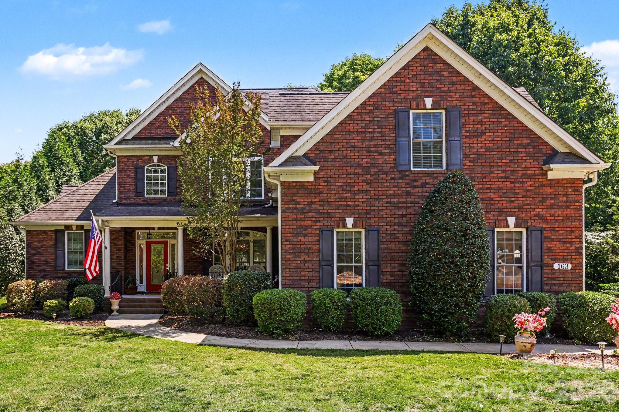 Private 1-acre homesite • No HOA • Luxury-renovated baths • Rare Brazilian countertops • Primary suite on main • Full-brick custom home.
Timeless craftsmanship, luxury upgrades, and everyday functionality come together on a beautifully manicured one-acre lot in the heart of Lake Wylie. This full brick custom home offers the rare combination of privacy, elegance, and convenience with no HOA and an exceptional layout designed for both entertaining and comfortable daily living. The yard has mature landscaping, expansive frontage, and a fully fenced in flat back yard.
Inside, soaring ceilings and a stunning two-story great room create an impressive first impression while still feeling warm and inviting. Rich oak hardwood flooring, updated luxury finishes, and thoughtfully renovated spaces elevate the home throughout.
The layout is one of this home’s strongest features. The kitchen serves as the true heart of the home, positioned perfectly between two separate living spaces to create exceptional flow for entertaining, gathering, or simply spreading out comfortably. Easy access to the rear deck extends the living space outdoors, creating an ideal setup for hosting guests, enjoying quiet evenings, or taking in the peaceful surroundings of the fenced backyard and private lot.
The spacious primary suite on the main level offers a true retreat with updated bathrooms and refined finishes that bring both comfort and sophistication. Upstairs, additional bedrooms and flexible living space provide room for family, guests, home offices, or recreation.
Luxury details throughout the home include rare Brazilian countertops expanding to the backsplash, updated fireplace surrounds, modernized bathrooms, upgraded lighting, and designer touches that make the property feel elevated yet livable. Recent updates including fresh paint and carpeting upstairs further enhance the move-in-ready appeal.
Beyond the beauty of the home itself, the property offers a lifestyle that is increasingly difficult to find in the Lake Wylie market — a private one-acre setting without HOA restrictions while still being conveniently located near Lake Wylie amenities, Clover schools, shopping, dining, and quick access into Charlotte.
Homes with this level of space, privacy, functionality, and tasteful updates rarely become available. This is more than a home — it is a property designed to live beautifully for years to come
