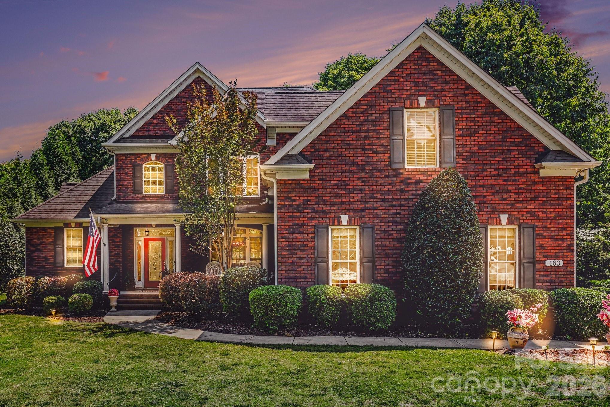 Welcome to 163 Evening Shadow Road — where timeless craftsmanship, luxury upgrades, and everyday functionality come together on a beautifully manicured one-acre lot in the heart of Lake Wylie. This full brick custom home offers the rare combination of privacy, elegance, and convenience with no HOA and an exceptional layout designed for both entertaining and comfortable daily living.
From the moment you arrive, the home’s presence stands out with mature landscaping, expansive frontage, and classic architectural appeal. Inside, soaring ceilings and a stunning two-story great room create an impressive first impression while still feeling warm and inviting. Rich oak hardwood flooring, updated luxury finishes, and thoughtfully renovated spaces elevate the home throughout.
The layout is one of this home’s strongest features. The kitchen serves as the true heart of the home, positioned perfectly between two separate living spaces to create exceptional flow for entertaining, gathering, or simply spreading out comfortably. Easy access to the rear deck extends the living space outdoors, creating an ideal setup for hosting guests, enjoying quiet evenings, or taking in the peaceful surroundings of the fenced backyard and private lot.
The spacious primary suite on the main level offers a true retreat with updated bathrooms and refined finishes that bring both comfort and sophistication. Upstairs, additional bedrooms and flexible living space provide room for family, guests, home offices, or recreation.
Luxury details throughout the home include rare Brazilian countertops, updated fireplace surrounds, modernized bathrooms, upgraded lighting, and designer touches that make the property feel elevated yet livable. Recent updates including fresh paint and carpeting further enhance the move-in-ready appeal.
Beyond the beauty of the home itself, the property offers a lifestyle that is increasingly difficult to find in the Lake Wylie market — a private one-acre setting without HOA restrictions while still being conveniently located near Lake Wylie amenities, Clover schools, shopping, dining, and quick access into Charlotte.
Homes with this level of space, privacy, functionality, and tasteful updates rarely become available. This is more than a home — it is a property designed to live beautifully for years to come
