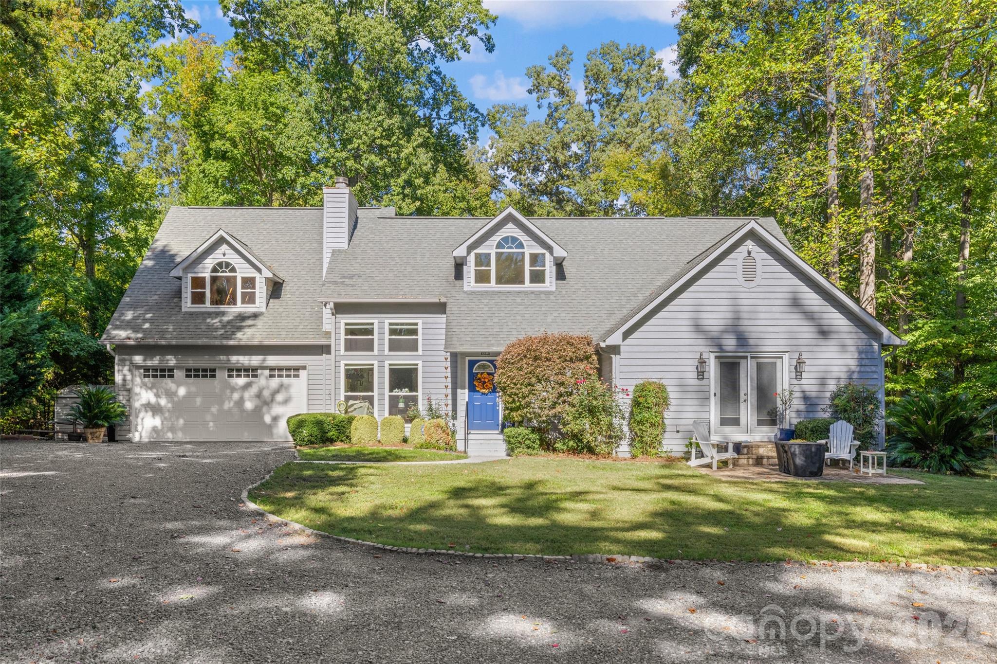 Wow, even our seasoned professional photographer has described this property as a true gem. Tucked away at the end of a peaceful cul-de-sac in Fort Mill, this distinctive home offers a perfect blend of privacy, space, and convenience. Situated on 3.08 acres, and NO HOA - it provides a serene retreat just five minutes from shopping, grocery stores, and dining options. This residence features four bedrooms and two and a half bathrooms, including a primary suite on the main level with a luxurious upgraded bathroom and a walk-in shower. The chef’s kitchen features modern upgrades and overlooks the beautifully landscaped surroundings, while the sunroom opens onto a spacious deck, ideal for taking in the tranquility of this unique property. The main level also includes a dedicated TV and game room, ideal for family and entertaining guests. For your RV, vehicles, and recreational equipment, the expansive 834 sq ft garage, combined with a circular driveway, provides ample storage and easy access. Throughout the home, you will find numerous upgrades, including new windows, hardwood floors, and carpet on the second floor. Additionally, there are substantial storage options and unfinished areas available for expansion. This exceptional property truly stands out in Fort Mill, offering privacy, convenience, and character all in one package.