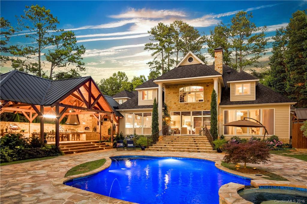 Unparalled post & beam outdoor pavilion with stone fireplace, summer kitchen, al fresco dining, pool & spa is the ideal setting for lavish lakeside entertaining & sensational sunsets. Home has been completely remodeled inside & out with high-end designer finishes. A Chef's Kitchen with two marble topped islands, all new bathrooms, flooring, & lighting. Walls of windows exemplify the lake ambiance of this home. New pier, a sandy beach, boardwalk, outdoor shower & bath. Fabulous lakefront living!