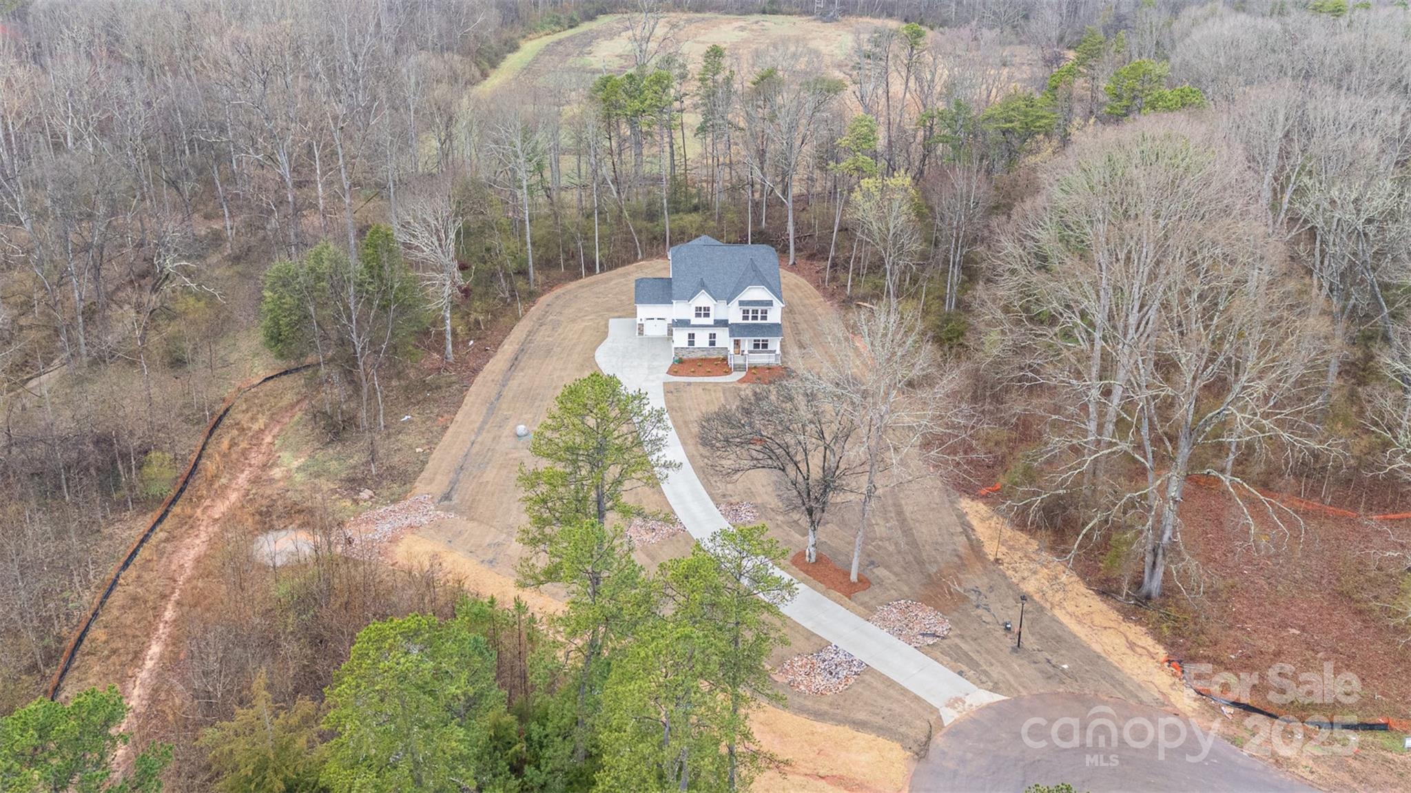 1+ ACRE, PRIVATE HOMESITE, NEW CONSTRUCTION - MOVE IN READY. Gorgeous 4 BR / 3.5 BA home on private, cul-de-sac lot. Beautiful open floor plan with 10' ceilings down & 9' ceilings up. Upstairs Owner Suite with Guest Suite on Main! Epicurean Kitchen with wood hood, floor to ceiling cabinets, double wall ovens, large island and quartz countertops, opens to family room with stone surround gas fireplace, & covered porch off dining area. Hardwoods throughout first floor (except Guest Suite), w/Guest Suite offering En Suite Bath. Study can also be used as formal dining. Owner suite has extra large, tiled walk-in shower, double vanities with quartz countertops, & large walk-in closet. 2nd floor has spacious loft & media room for fun and entertainment. Encapsulated crawl space! Must use preferred lender for incentive.