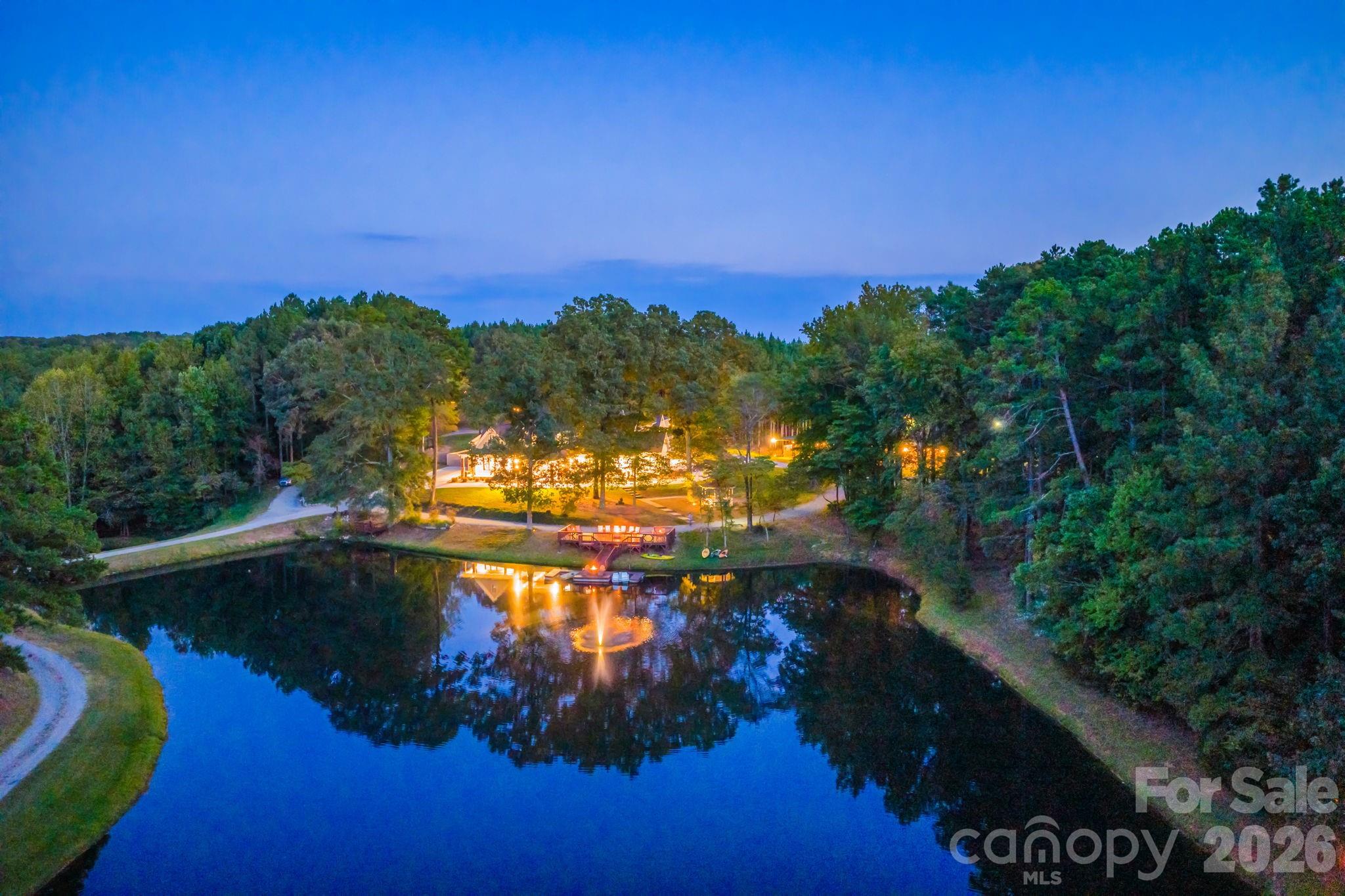Heartland Springs Farm offers a rare opportunity to own 39 private acres across three parcels, showcasing diverse terrain, an estate home and guest house, as well as, exceptional recreational amenities. Completed in spring 2024 after five years of careful planning and construction, this estate was envisioned as a timeless gathering place where family and friends can retreat, reconnect, and celebrate life’s most meaningful moments.
The custom-built 6,830-square-foot main residence features six bedrooms, six full baths, and two half baths, with a thoughtful split floor plan on the main level. Highlights include soaring 10’–12’ ceilings, custom oak mantles crafted from estate-harvested wood, Wolf appliances, custom cabinets, luxury vinyl plank flooring, crown molding, Quartz countertops and high-end luxury light fixtures. The Great Room, anchored by a floor-to-cathedral stone fireplace, flows into the dining room, chef’s kitchen, and all-seasons room overlooking the pool courtyard. A fully equipped scullery and butler’s pantry complement the kitchen, while the main-floor primary suite offers privacy opposite the en-suite guest room. Additional conveniences include dual staircases, remote-controlled blinds, a mudroom with full bath, large under-stairs storage, and a four-car garage. A lucky buyer has the option to make Heartland Springs their own since the previous buyer had a change of heart due to personal reasons only. Inspection report available for potential buyers and the items identified are being addressed/documented meaning you can move in and immediately start enjoying this special property.
The second floor accommodates three guest bedrooms, a loft/game room, family room with fireplace, flex/playroom, office/library, fitness room, and hidden bunk room. A walk-in attic with finished flooring provides generous storage.
Outdoor living is equally impressive. An all season room w/Coyote Stainless Steel Grilling area and fireplace open to the 48' x 18' pool/spa and Pavilion. Three ponds, including a house pond with dual aeration fountains, fire pit, and two observation decks with floating dock, invite fishing and relaxation. Miles of private, named trails are perfect for hiking, ATV adventures, or hunting. A guest house and versatile 5,055 sq ft entertainment barn expand the estate’s living and entertaining options, while numerous outdoor facilities support gatherings and recreation. Including the Hot Chocolate Shack & fire pit, and Hallelujah Hill.
The land itself is a blend of managed timber and natural beauty. Approximately 21 acres in Present Use Timber Program.
Designed as much for connection as for comfort, Heartland Springs embraces both lively social events and quiet reflection. Floor-to-ceiling windows and covered verandas blur the line between indoors and nature, while handcrafted details and locally sourced materials root the estate in authenticity.
Whether envisioned as a family compound, private retreat, or legacy estate, Heartland Springs Farm is a place where generations can gather, friends can reconnect, and the art of genuine presence can thrive.