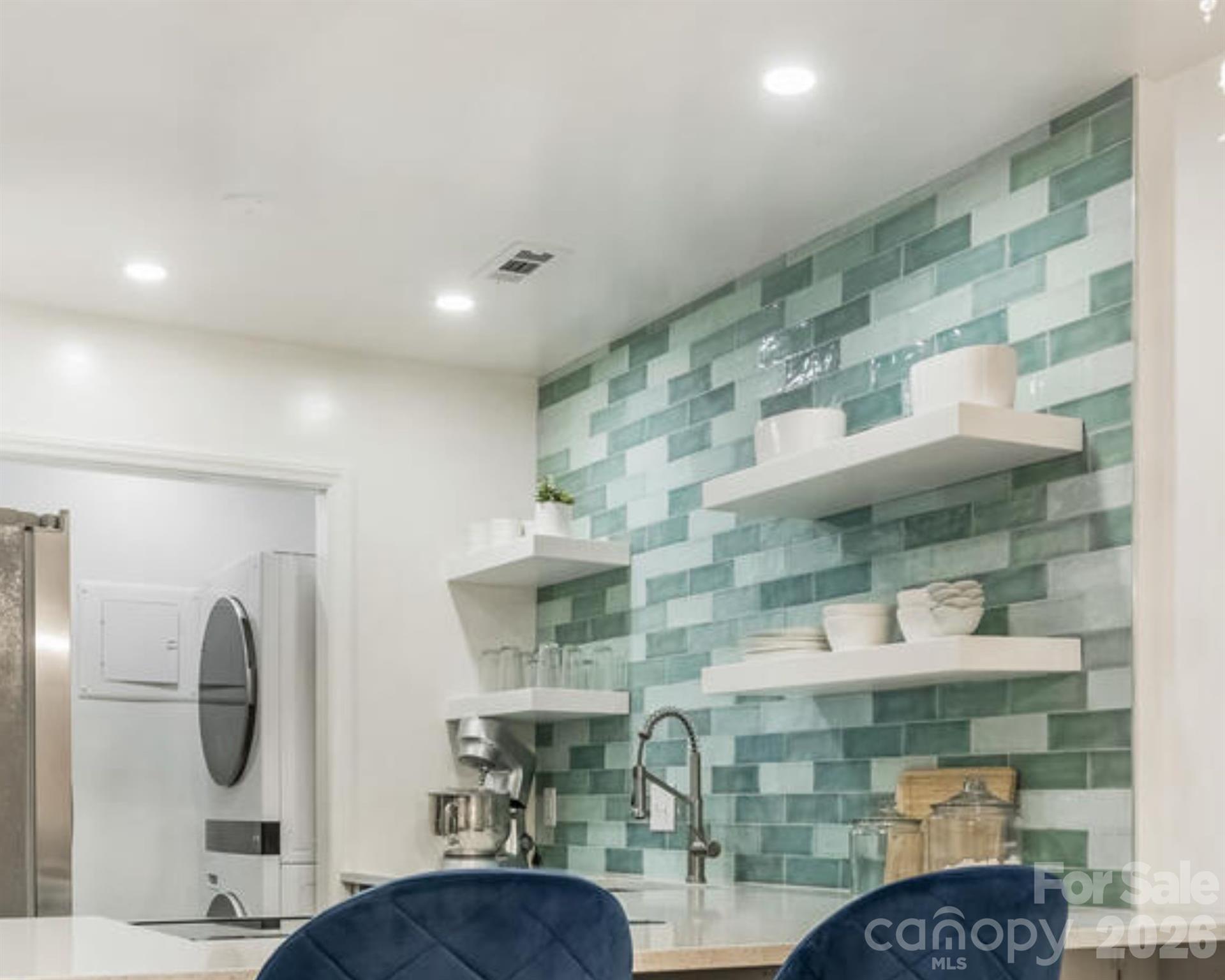 5K SELLERS CREDIT OR 12 MONTHS OF HOA DUES PAID BY SELLER! Make this stunning, well kept, condo your next home.  After a long day you'll feel relaxation the moment you enter! Beautiful flooring greets you alongside large windows that easily fill the space with natural sunlight. Pamper yourself while in the kitchen amongst soft close cabinets, gorgeous tiled wall, custom built floating shelves, recessed lighting, designer sink & faucet all embraced in Quartz countertops. Need space? No problem. Laundry & updated pantry area to accommodate easy access and add organized space. Hall closet is set up with wooden shelves for additional storage.  Bedrooms are a split floor plan to assist with privacy; both include a full bathroom.  The primary bedroom includes a large walk-in closet and private balcony.  Roof & water heater replaced in 2024.  Washer/Dryer remains along with the free standing microwave nestled away from the countertop view.  Make your appointment to view today and see all the upgrades in person, like the fireplace mantel; designed & custom made from a barn in PA! Ideally located just minutes from Quail Corners and SouthPark’s premier shopping and dining, with convenient light rail access for an easy commute to Uptown Charlotte.-