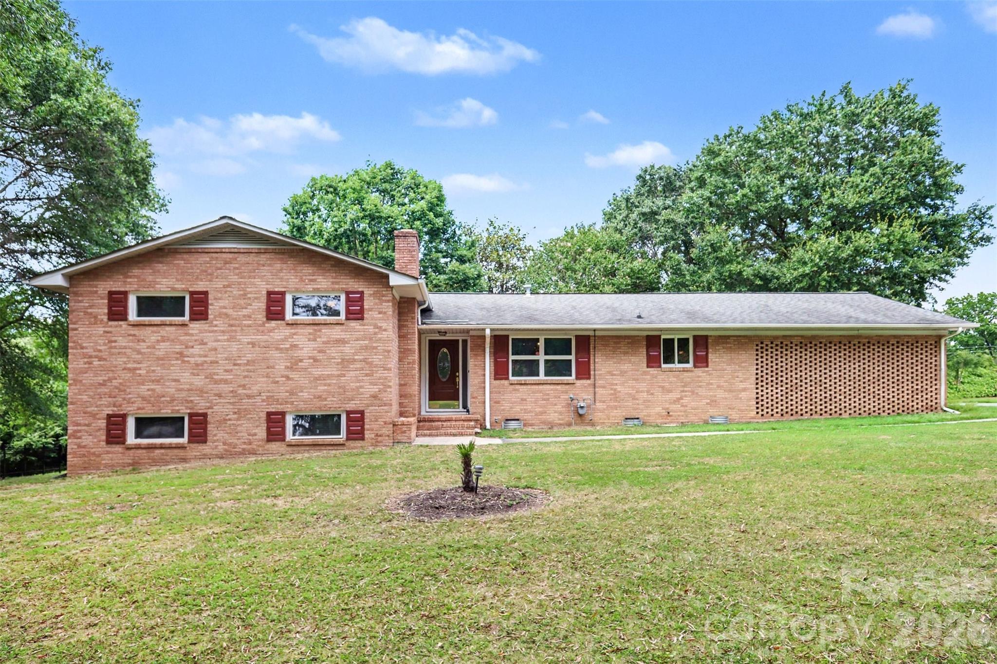 Spacious Split-Level Brick Home with Dual Primary Suites on a Corner Lot! No HOA!
Welcome to this spacious 4-bedroom, 3-full-bath split-level full brick home situated on a desirable corner lot with plenty of parking space.
Designed with flexibility in mind, this home features two primary suites—one on the upper level and one on the lower level—making it ideal for multi-generational living, extended guests, or a private retreat. 2 more bedrooms upstairs share a full bath in the hall. 
The main level offers a functional layout with a generously sized living space, kitchen and dining room. Downstairs, you'll find an expansive second living area featuring a wood-burning fireplace, currently set up as a home theater, making it the perfect space for movie nights, entertaining, or relaxing with family.
Step outside to enjoy the welcoming screened-in back porch overlooking the mature, tree-shaded yard. The three-sided fenced yard provides plenty of room for pets, play, gardening, or outdoor gatherings. 
Conveniently located right off I485, close to the Whitewater Center, Douglas Airport, and uptown Charlotte. Stop by to check it out and make it your own.