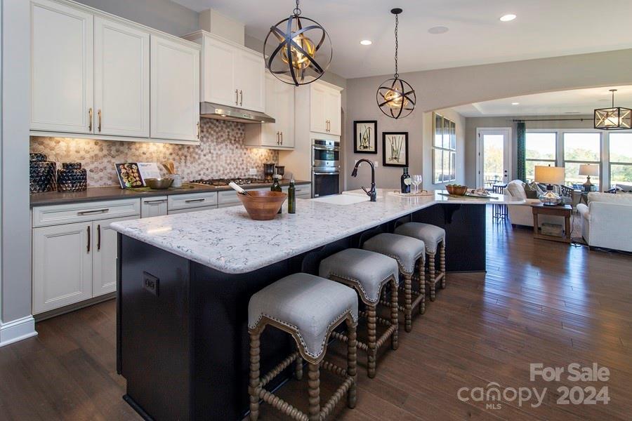MLS#4165330    REPRESENTATIVE PHOTOS ADDED. January Completion!  The Whitmore II at Estates at Sugar Creek presents a spacious ranch-style layout designed around an expansive open-concept entertaining space. Its centerpiece features a large gathering room seamlessly connected to a casual dining area and a stunning kitchen with a unique boomerang-shaped center island. Adjacent to the foyer, a dedicated dining room caters to formal affairs. A flexible room is down the hall from the owner’s suite, perfect for versatile use, and walk-in closets in both secondary bedrooms for ample storage. The owner’s suite boasts a luxurious bath, large walk-in closet, dual sinks, and an expansive walk-in shower. Upstairs, a loft area complements an attic suite and game room, adding additional living space and flexibility to accommodate various lifestyles. Structural options added include: extended walk in shower in primary bath, sunroom, fireplace, loft with attic suite and game room.