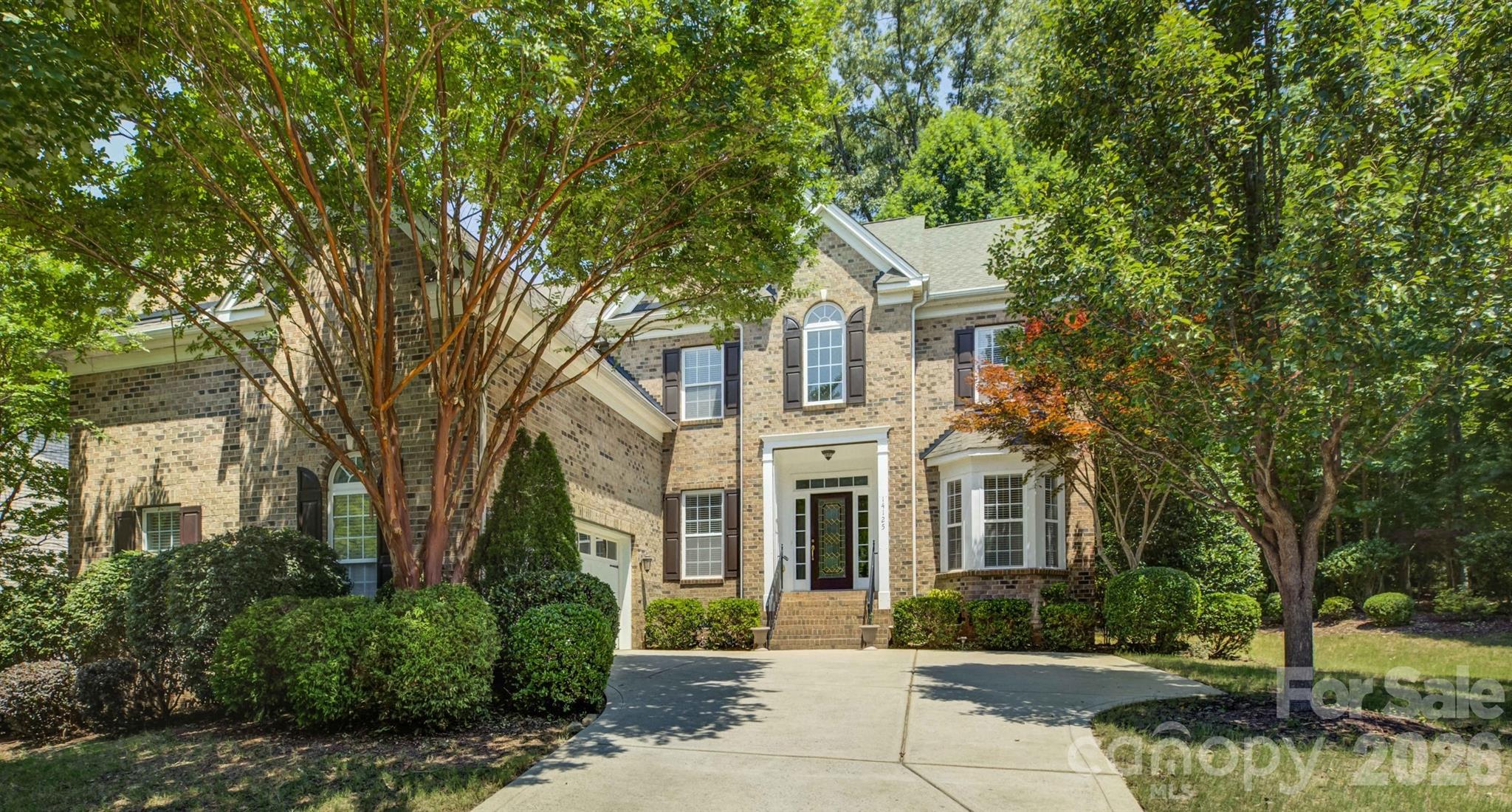 Perfectly situated on a quiet cul-de-sac in the highly sought-after Palisades community, this exceptional home offers breathtaking wooded views of the neighborhood, walking trails, and views of the Jack Nicklaus-designed golf course, creating a peaceful backdrop for everyday living. A welcoming foyer opens to an elegant formal dining room, while the soaring two-story great room is flooded with natural light from an impressive wall of windows. The well-appointed kitchen features expansive granite countertops, abundant cabinetry, and a sunny breakfast area with a charming bay window bump-out, ideal for casual meals. The adjoining family room is anchored by a cozy gas fireplace and seamlessly extends outdoors to an oversized deck and paver patio, perfect for entertaining or relaxing while enjoying the private setting. A versatile main-level guest suite with a dramatic floor-to-ceiling bay window can also serve as a private home office or study. Upstairs, the spacious primary retreat showcases elegant arched millwork, dual separate vanities, a glass-enclosed shower, and a generous walk-in closet. Two additional bedrooms share a hall bath, while the oversized bonus room offers endless flexibility as a media room, recreation space, fifth bedroom, or playroom. Residents of the amenity-rich Palisades enjoy resort-style living with a clubhouse, fitness center, Olympic-sized swimming pool, tennis and pickleball courts, basketball courts, playground, miles of scenic walking trails with optional memberships available to the renowned Jack Nicklaus-designed Palisades Country Club featuring championship golf, dining, tennis, pool and additional social amenities.