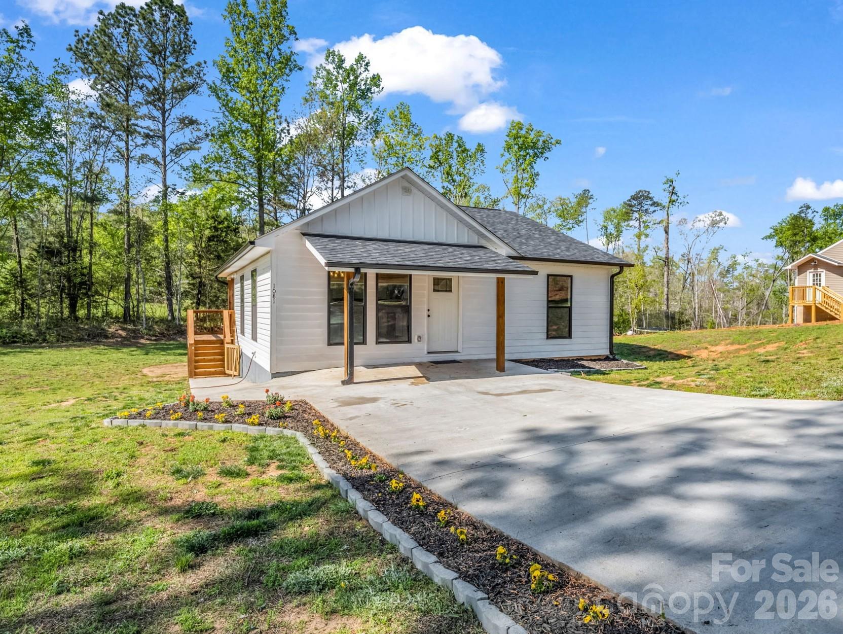 Seeking a peaceful place to call home? Discover this modern farmhouse on just under an acre in rural Bostic. Enjoy morning coffee on the expansive covered deck while taking in serene natural views, then take a short 15-minute drive to historic Forest City for dining and shopping. This well-appointed residence offers 2 bedrooms, 2 bathrooms, and an open-concept living room and kitchen—ideal for comfortable, relaxed living.