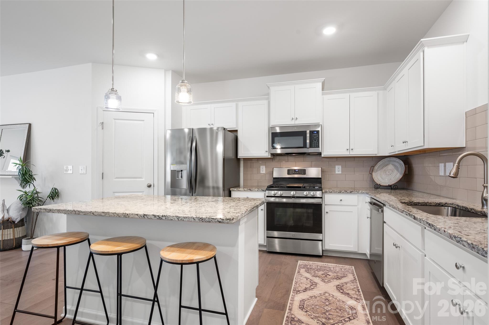 Fantastic opportunity to own a better-than-new townhome in Matthews! The open-concept first-floor layout is ideal for hosting guests and everyday living. A custom, floor-to-ceiling built-in bookshelf in the living room provides exceptional storage. The first-floor half bath is beautifully upgraded with board-and-batten trim and designer wallpaper. The attached 1-car garage includes ceiling-mounted storage shelves, offering excellent organization and maximizing usable space.

Upstairs, the spacious primary suite easily accommodates a sitting area. The primary bathroom features a dual vanity, a walk-in glass-enclosed shower, and flows to a generous walk-in closet. Two additional guest bedrooms are also located on the upper level, one of which includes a custom-installed Murphy bed that allows for multi-purpose, space-saving use. **Murphy bed can be removed at sellers' cost if preferred.

Additional upgrades throughout the home include window shades, updated light fixtures and ceiling fans, fresh paint, and a recently installed storm door.

The sellers love the neighborhood’s walkability and its close proximity to multiple parks and greenways. Harpers Run is conveniently located just minutes from downtown Matthews, I-485, the new Atrium Health Union West, and everyday essentials including groceries, shopping, plus dining in Stallings, Indian Trail, and South Charlotte! Home is investor friendly with minimum 12 month leases allowed. No rental cap!