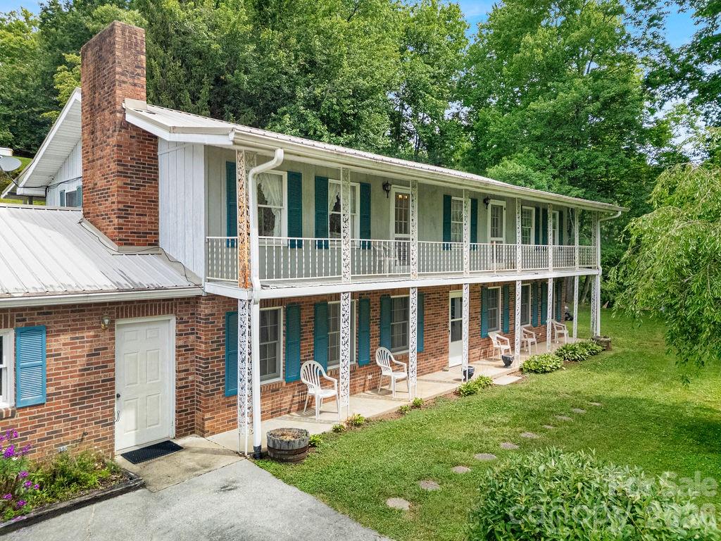 Welcome to 106 Flora-Lina Drive in Brevard, NC! This well-cared for, one-owner home sits on +/-3.27 unrestricted acres in one of Transylvania County's most desirable locations offering the perfect combination of privacy, flexibility, and convenience. Ideally situated just minutes from downtown Brevard, Pisgah National Forest, and DuPont State Forest, yet outside of the city limits, you'll enjoy easy access to world-class hiking, mountain biking, waterfalls, dining, and shopping while still enjoying the peace and beauty of a mountain setting.

The home itself features a durable brick exterior, attached garage, whole-home generator, and a versatile floor plan that includes a fully equipped in-law suite complete with its own kitchen, large living area, and ample storage—ideal for multigenerational living, guest accommodations, rental income, or a private home-office setup.

A year-round stream meanders through the lower portion of the property, creating a serene natural setting, while seasonal winter views provide a beautiful backdrop of the surrounding mountains. The unrestricted acreage offers endless possibilities for gardening, recreation, homesteading, short-term rentals, and ideal additional build site(s) for future expansion.

Whether you're seeking a primary residence, mountain retreat, investment opportunity, or family compound, this unique property delivers the freedom of unrestricted land in a highly sought-after location near Brevard's outdoor recreation and vibrant downtown. Bring your vision to life at 106 Flora-Lina Drive.