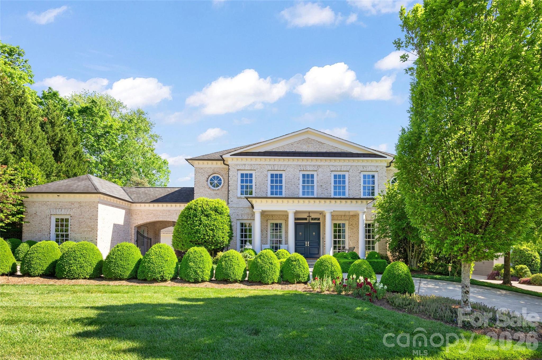 Incredible, one-of-a-kind residence in sought-after Stonegate, showcasing timeless Georgian architecture and impeccable craftsmanship. Built by Kingswood Custom Homes, this pristine estate sits on a beautifully landscaped .45-acre lot and offers 6 bedrooms/7.2 bathrooms with the primary bedroom on the main level. Exceptional outdoor living—featuring a heated saltwater pool and spa with sundeck, and a covered terrace with heaters, in-ceiling speakers, retractable shades, and a built-in grilling station. A stunning pool house with vaulted ceilings, full bath, and kitchenette completes the resort-style setting. Inside, high ceilings, intricate moldings, and gleaming hardwoods define the elegant interiors. A grand foyer opens to the formal dining room, study with custom built-ins, and a temperature-controlled wine room with exposed brick. The open-concept living area seamlessly blends the family room, sunroom, and chef’s kitchen—appointed with custom cabinetry, Wolf and Sub-Zero appliances, center island with Carrera marble countertops, and a scullery with double beverage fridge and walk-in pantry. The main-level primary suite offers a spa-like bath and expansive walk-in closet. Four secondary bedrooms feature en-suite baths and walk-in closets, while a private sixth suite above the attached garage provides ideal guest accommodations or flexible bonus space. Two large recreation spaces to fit any buyer need! Complete with dual laundry spaces, generator, and attached 2-car garage and an additional 1-car garage, this exceptional home delivers luxury living at its finest! Just minutes to Southpark, Quail Hollow and desirable public and private schools this is an extraordinary opportunity to own a meticulously cared for, immaculate, move-in ready home!