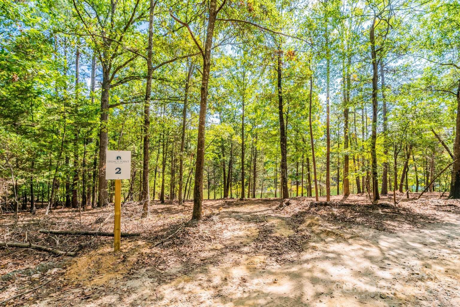 YOU FOUND IT! NO HOA, LARGE ACREAGE, WATERFRONT PROPERTY ON LAKE WYLIE! Experience Premier Lakefront Living on Lake Wylie - discover the freedom of this 5+ acre, waterfront estate. Presenting a once-in-a-generation opportunity to claim an estate of 5+ acres of prime lakefront property in York, SC! This exceptional estate offers: -No HOA or CCRs provide complete freedom to design your dream home exactly as you envision it. -Enjoy total privacy surrounded by your spacious lot, tucked into a serene, wooded enclave just off the main channel of the lake. -Located in the highly rated Clover School District, with low York County taxes makes this property ideal for your new custom home or investors alike. Why Legacy Point? -Immediate access to Lake Wylie's 13,400-acre playground for boating, fishing, and kayaking all at your doorstep. -A living legacy: part of a historic, man-made lake dating back to 1904, rich with story and community. -A quick commute just 30 minutes to Charlotte, airport access, dining, entertainment, and premier shopping.