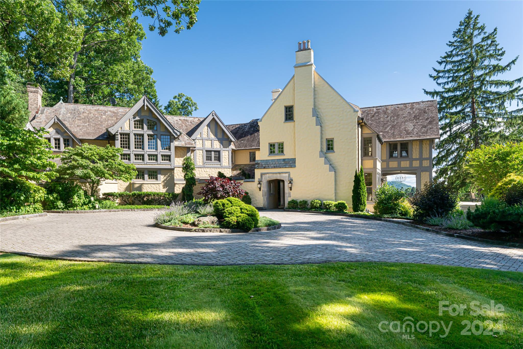 Step into a marvel of architectural excellence and enduring grace, envisioned by the renowned architect Richard Sharp Smith for Burnham S. Colburn in the esteemed enclave of Biltmore Forest. Reimagined by Robert Griffin in the early 2000s, this English country Manor rests gracefully on 4.4 acres. As you approach, the estate commands attention with its poised presence amidst manicured lawns, seasonal gardens, serene water features, and panoramic views of the private golf course. Inside the 7BR/5/2BA residence, an open floor plan seamlessly connects the living spaces, fostering an inviting environment for gatherings and relaxation. The timeless elegance of the home is enhanced by the finest materials and craftsmanship, exemplifying meticulous attention to detail. Entertain with finesse in the lower-level kitchen and grilling area, complemented by a resort-style pool and expansive terrace.The property is replete with amenities,including a greenhouse, stables, and a 3BR/2BA carriage house.