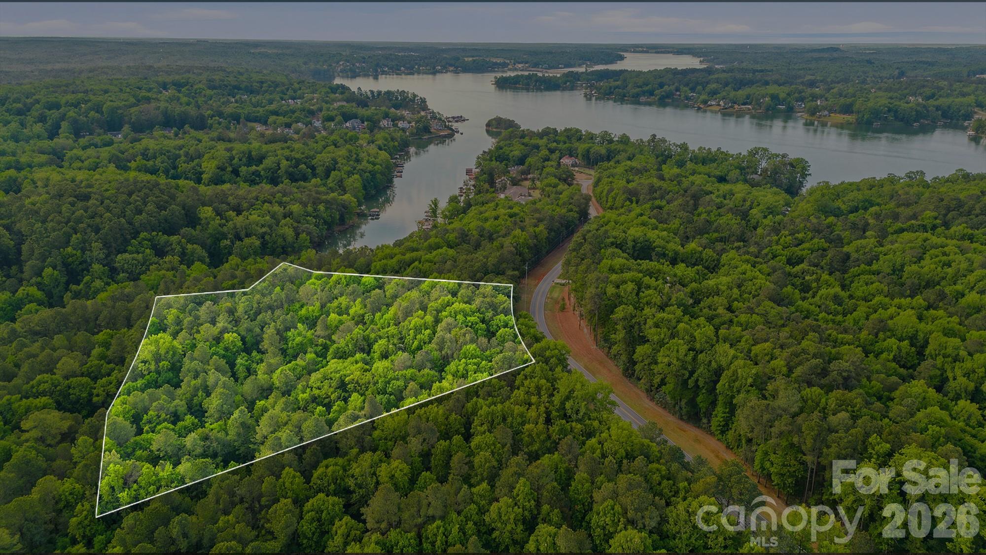 Tucked within the exclusive community of The Sanctuary, this rare 6 acre waterfront homesite offers the ideal canvas to create a custom retreat with a blend of privacy, nature, and luxury living. Set along a quiet cove of Lake Wylie, this property provides a serene backdrop to build your custom dream home, surrounded by mature trees and protected natural beauty. Enjoy access to world-class community amenities including a clubhouse, fitness center, pool, tennis courts, walking trails, and more—all designed to complement an active yet peaceful lifestyle. This is your chance to create a truly one-of-a-kind retreat in one of Charlotte’s most sought-after waterfront communities. The Sanctuary is known for its preserved landscape, estate sized lots and unmatched sense of privacy. Only minutes away from dining, shopping and Charlotte Douglas International Airport.