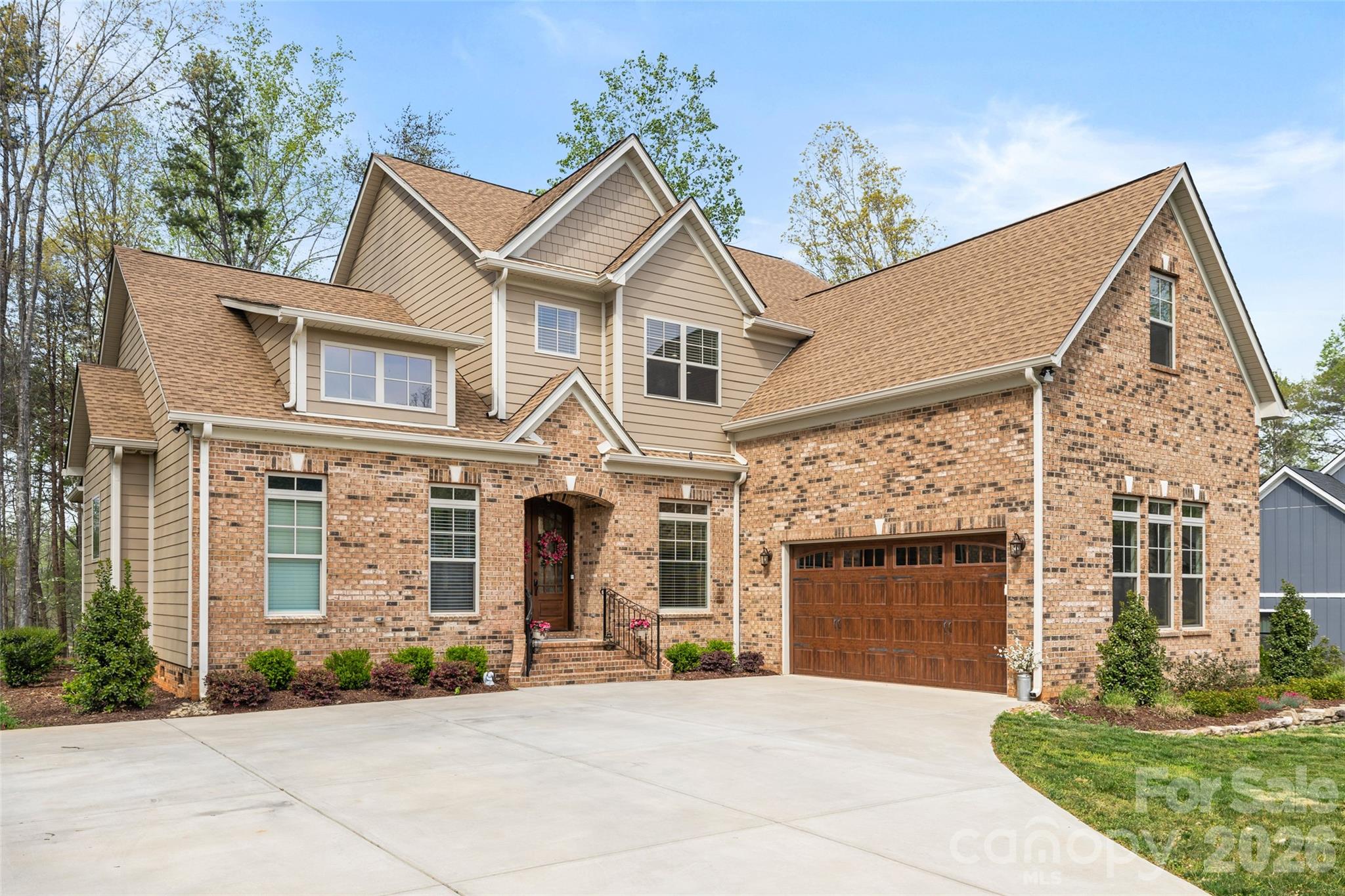 Welcome to this stunning two-story Mediterranean-inspired custom estate home, where timeless elegance meets modern comfort within a serene, private setting and over an acre of land. 

The grand double-door entry opens into an elegant foyer, where a private home office sits perfectly positioned at the front of the home - ideal for quiet productivity. Beyond, the residence unfolds into a breathtaking great room, highlighted by soaring 23-foot ceilings and a dramatic floor-to-ceiling stone fireplace with a solid wood mantle. The wall of windows floods the space with natural light, creating a warm and inviting atmosphere.

Designed for both everyday living and entertaining, the open-concept layout flows seamlessly into a chef’s kitchen featuring an oversized island with seating, gas cooktop with hood, double wall oven, stainless steel appliances, tile backsplash, and under-cabinet lighting. Enjoy casual meals in the cozy breakfast nook - complete with its own stone fireplace - or host elegant dinners in the formal dining room adorned with a tray ceiling and chandelier.

The main-floor primary suite is a true retreat, offering an oversized layout with tray ceiling and chandelier, along with a spa-inspired ensuite bath. Indulge in Italian marble flooring, a dual sink vanity, soaking tub, and an expansive walk-in shower with floor-to-ceiling tile.

Throughout the home, you’ll find refined architectural details including graceful archways, custom cabinetry, solid core doors, and designer blinds. The thoughtfully designed laundry room features custom tile, a utility sink, and ample cabinetry for added convenience.

Upstairs, a spacious loft and a large, finished bonus room provide flexible living space for recreation or relaxation. Two generously sized guest bedrooms share a beautifully appointed Jack-and-Jill bathroom with custom tile flooring.

Step outside to the enclosed patio just off the great room, complete with a ceiling fan and peaceful wooded views that lead down to a quiet pond. Whether kayaking, fishing, or simply enjoying quiet evenings by the water, this property offers a rare connection to nature.

Located within the exclusive Irongate community, residents enjoy gated access, scenic walking trails, and close proximity to Lake Wylie & Tega Cay.

This exceptional home combines luxury, privacy, and thoughtful design - an extraordinary opportunity to experience elevated living.
