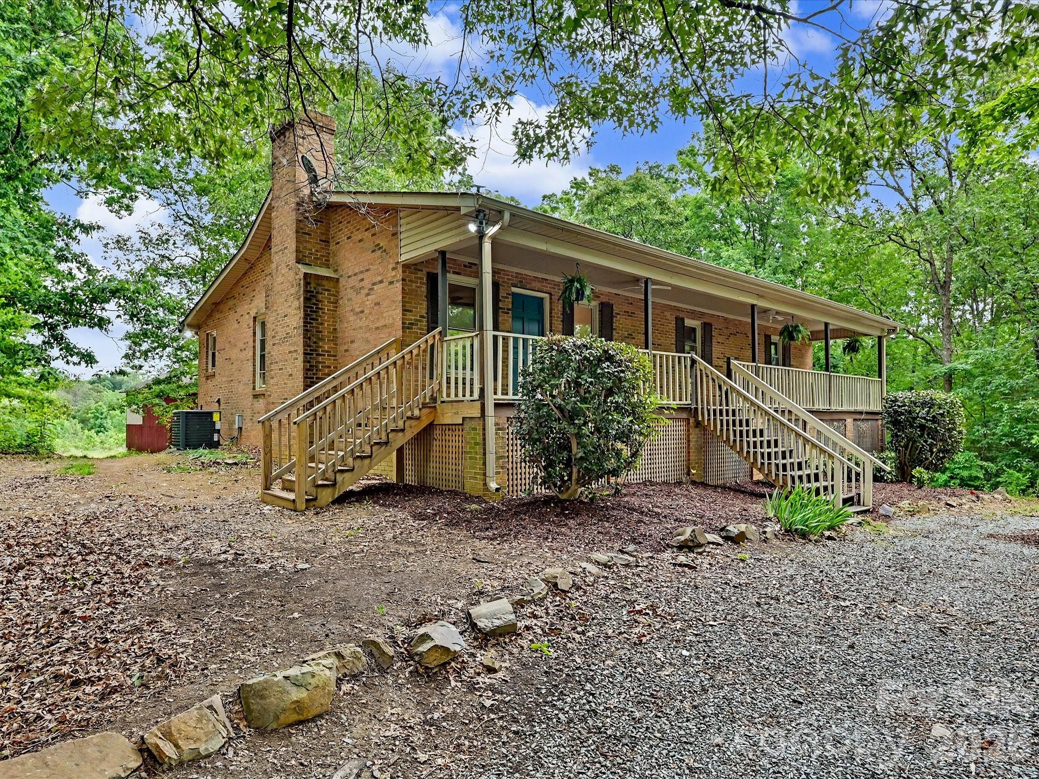 Welcome to your private slice of country living—where charm, space, and opportunity come together on 28 beautiful acres. This classic brick home greets you with a large, inviting front porch—perfect for morning coffee, evening sunsets, and everything in between.

The property offers a versatile mix of open land and mature wooded areas, creating the ideal setting for farming, recreation, or bringing your equestrian dreams to life. Whether you envision pastures, trails, or simply enjoying the peace and privacy, this land delivers.

Inside, you’ll find a warm and functional layout featuring durable LVP flooring throughout and a cozy fireplace anchoring the living room. The home includes 3 bedrooms and 3 full bathrooms, offering comfortable space for family and guests. Kitchen complete with kitchen island with an overhang perfect for bar stools, and custom tiled backsplash, and open floorplan into the dining area and living room.

The finished 700-square-foot walk-out basement provides additional living or flex space—perfect for a home office, recreation room, or guest suite—with easy access to the outdoors with added peace of mind from French drains installed around the basement. Enjoy the outdoors year-round with both a screened-in back porch and an open back porch—ideal for relaxing or entertaining while overlooking your expansive property. 

Outside, the possibilities continue with an oversized 1,200+ square foot tractor barn with electricity and an additional 520 square foot shed, also with electricity, perfect for a workshop, storage, or hobby space.

Tucked away yet conveniently located just minutes from town and bypass, this property offers the rare balance of seclusion and accessibility. Whether you're looking to expand, homestead, or simply enjoy room to roam, this one has the potential to make it all happen.