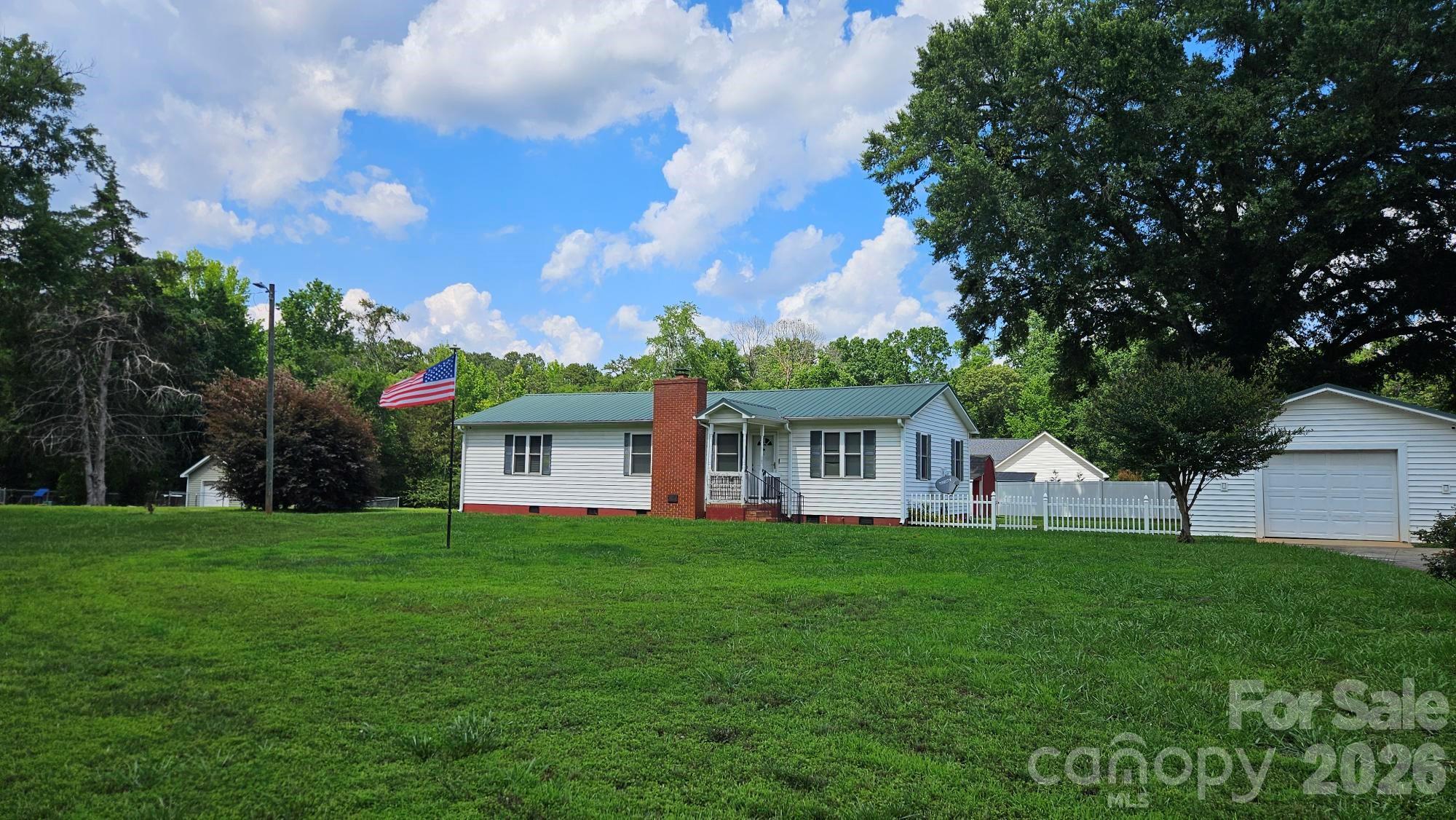 Tucked away in the quiet countryside of Rock Hill. this inviting 3-bedroom, 2-bath home offers the kind of space and layout that just works. The open floor plan flows effortlessly, with a kitchen that features a functional island and breakfast bar overlooking the living and dining areas, all highlighted by a vaulted ceiling that adds to the sense of openness.

The living room centers around a cozy gas-log fireplace, perfect for winding down at the end of the day. Step outside to a spacious covered deck made for both entertaining and enjoying a little peace and privacy, with partial fencing already in place.

Car lovers, hobbyists, or anyone tired of fighting for garage space will appreciate the massive 975 sq ft garage, fully wired and ready to go. Add your own personal touch and you’ve got a property that delivers comfort, function, and a little breathing room from the chaos of everything else.