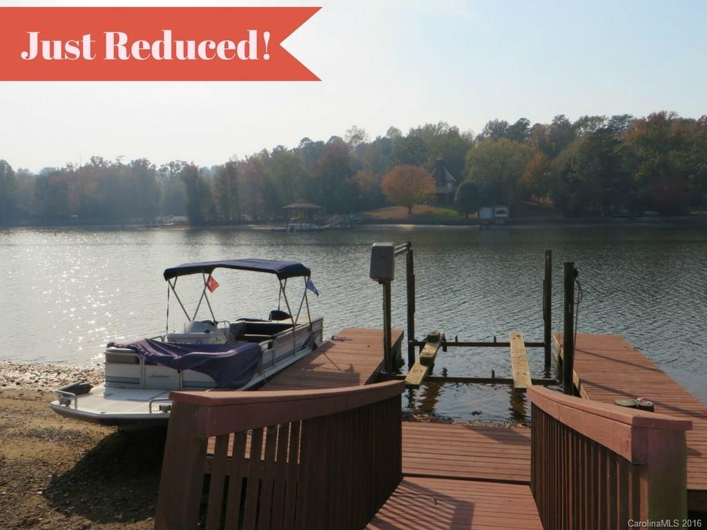 Awesome views from every room of this beautiful WATERFRONT home! Big, open, entertaining space w/vaulted GR/DR area that opens to side deck. Kitchen has loads of cabinet/counter space, lg. work island.  1st floor Master has large WIC & dressing area+office/study. M. Bath w/dual vanities.   Lower level has 2nd bedroom, Den w/FP and bar opens into back yard to Lake. 2nd living quarters above garage has kitchenette, bedrm, full bath, living rm. Your own private beach with floating dock & boat lift!