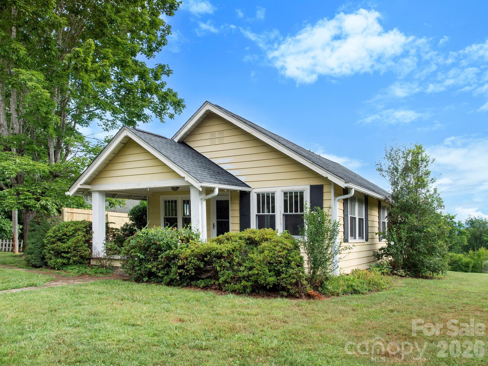 Charming bungalow with mountain views, tucked into a peaceful neighborhood setting. This home blends original character with thoughtful updates, including energy-efficient replacement windows designed with four-pane upper sashes to preserve the home’s classic charm. The former oil heat has been replaced with electric HVAC, offering the comfort of central air, and the roof has also been replaced with a transferable warranty for added peace of mind. With its inviting feel, lovely views, and timeless bungalow appeal, this home is ready for its next chapter. It could benefit from some TLC and is being sold as-is.
