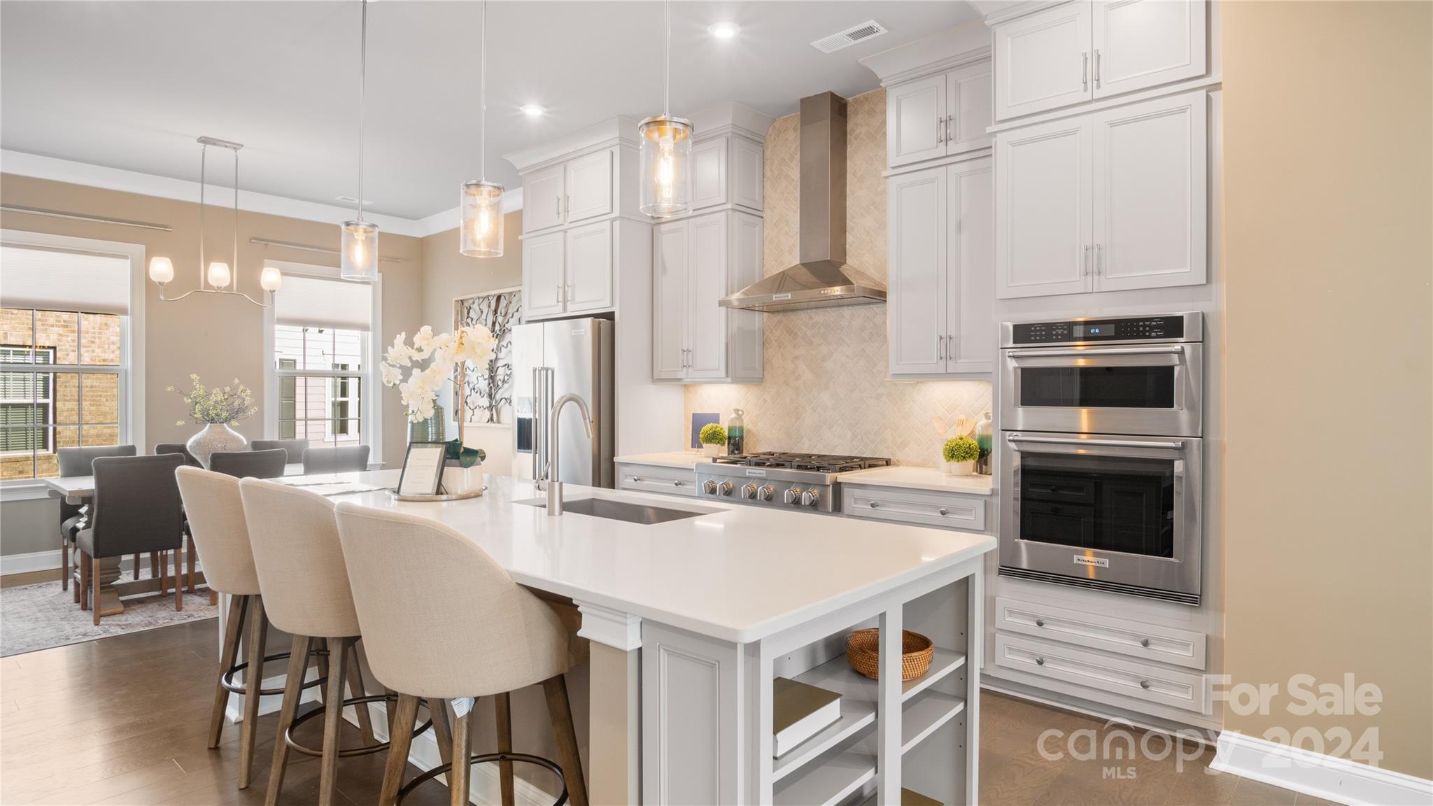 Welcome to Elizabeth Glen, where convenience and luxury combine. This 2023 John Wieland built Broxton model with full brick front elevation includes a ground floor ensuite bedroom and a two-car rear garage WITH a full driveway for additional parking.  The second floor features an open concept, a Sunroom, island kitchen and dining area. You'll also be able to enjoy one of two outdoor spaces with balcony on this level just outside of the sunroom.  The third floor includes the spacious primary suite that includes TWO walk in closets as well as the guest suite that has its own private bath.  Let's not forget about the cherry on top, which is the fourth floor Sky Terrace and a bonus room that can function as a flex space and includes a half bath.  Don't miss this good as new townhome with more than $29,000 in upgrades completed by the owners! Schedule your showing today!