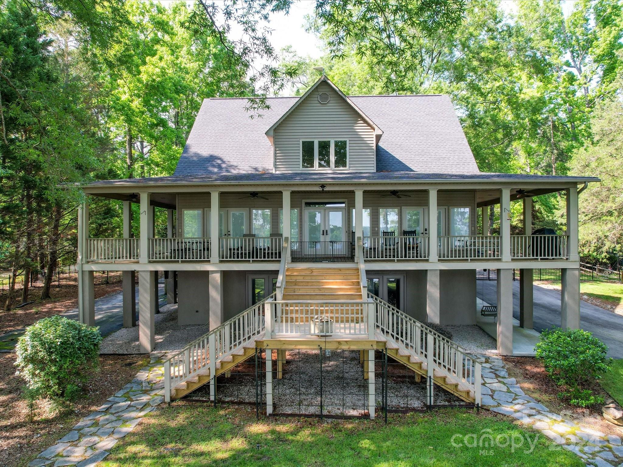 Situated on a little more than an acre this stunning Lake Wateree home could be your perfect weekend getaway. Home features 5 bedrooms, 4.5 baths and a heat/cooled apartment with a murphy bed above the detached garage. Enjoy breath taking views on a massive wrap around porch with an elevator connected to the main and basement level. The interior floor plan is open and has hardwoods and carpet throughout with high ceilings. The kitchen includes granite countertops, and an island equipped with a prep sink. Owner bedroom has lake view, private bathroom, a walk in closet and a convenient exit to the deck. Equipped with Honeywell generator.